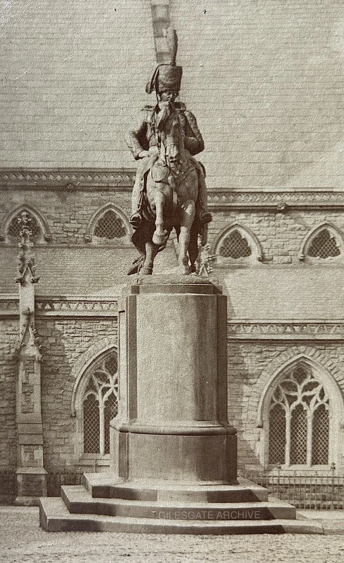 A sepia image of the statue of Charles, 3rd Marquess of Londonderry in his hussars uniform on a horse, situated outside St Nicholas' church in Durham Market Place