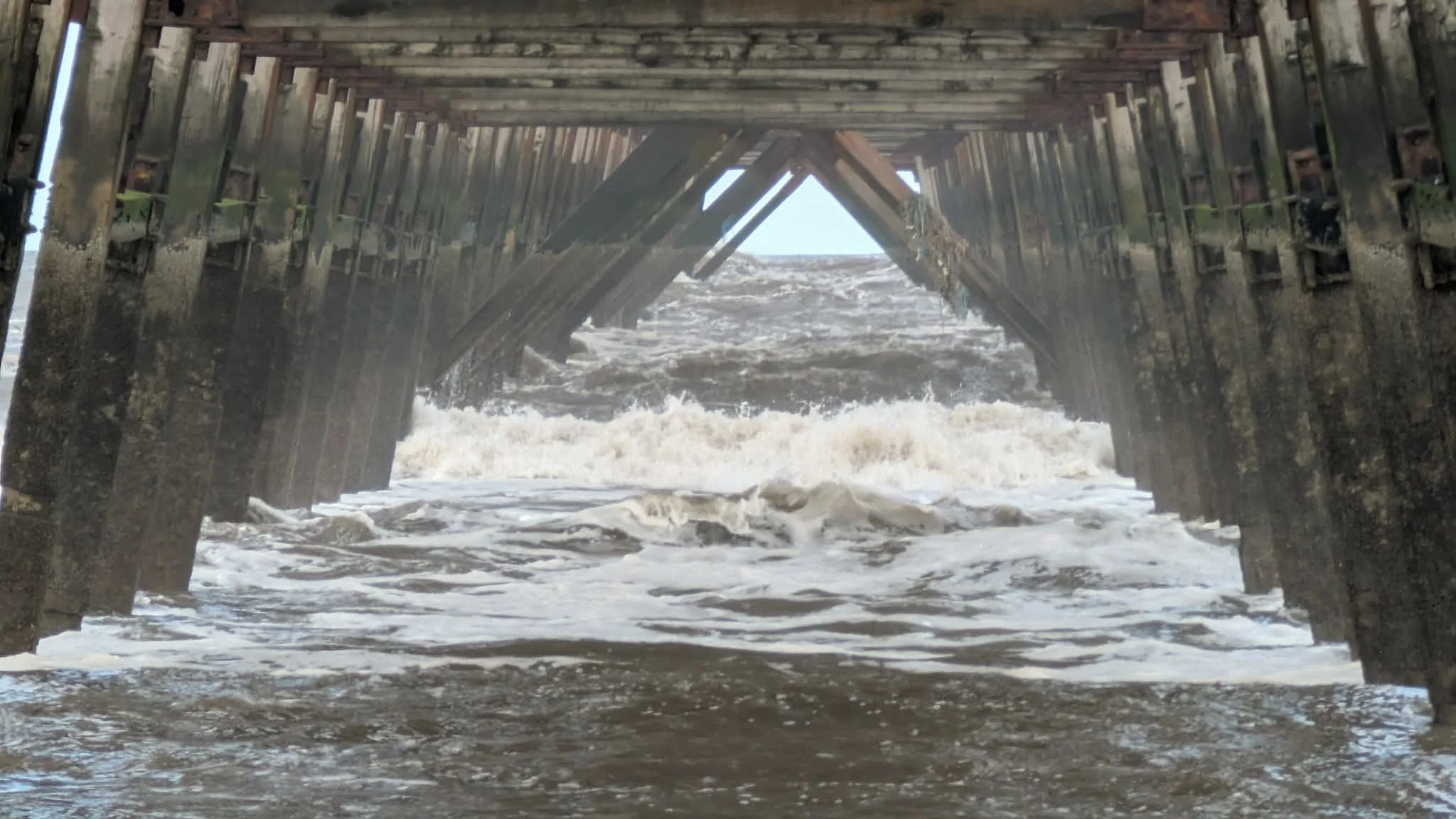 The waves breaking under Hartlepool pier