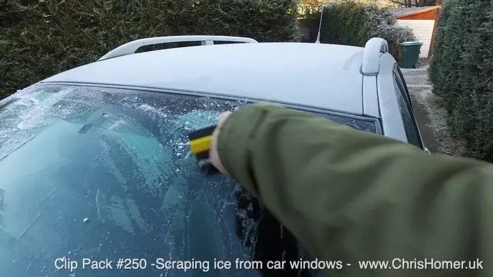 Winter stock footage - Scraping ice from a car window stock video footage