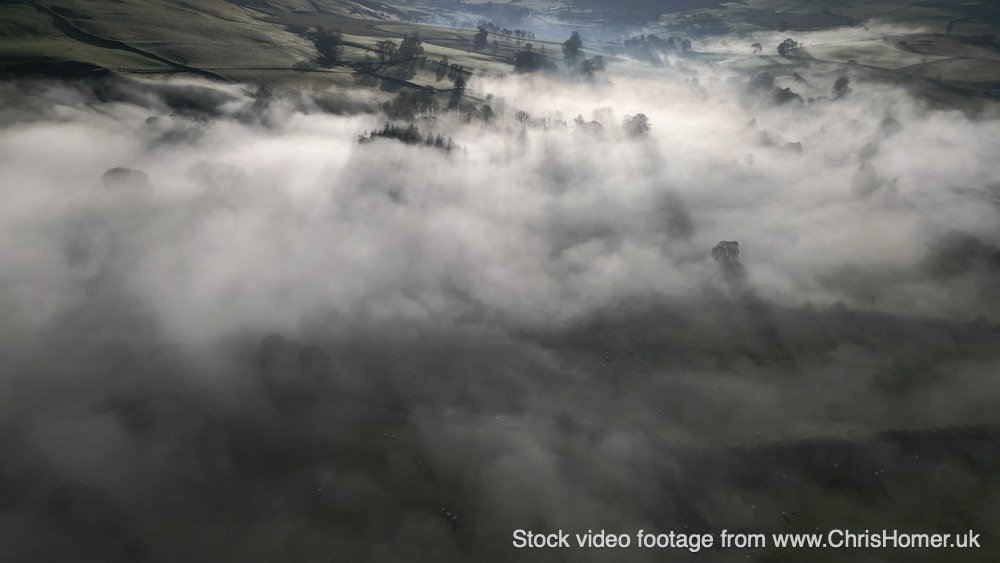 Experience the breathtaking beauty of low-hanging fog drifting through the English countryside with this stunning 4K drone footage