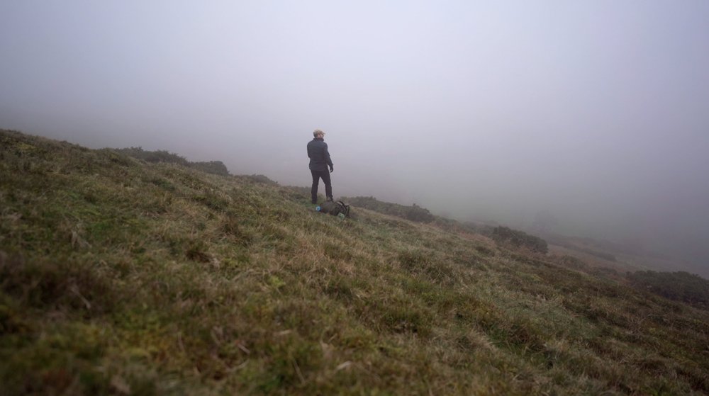 A man on a foggy English hillside cloudy stock video footage