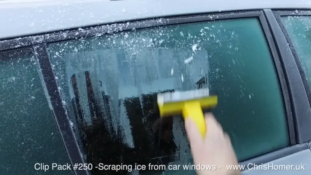 Winter stock footage - Scraping ice from a car window stock video footage