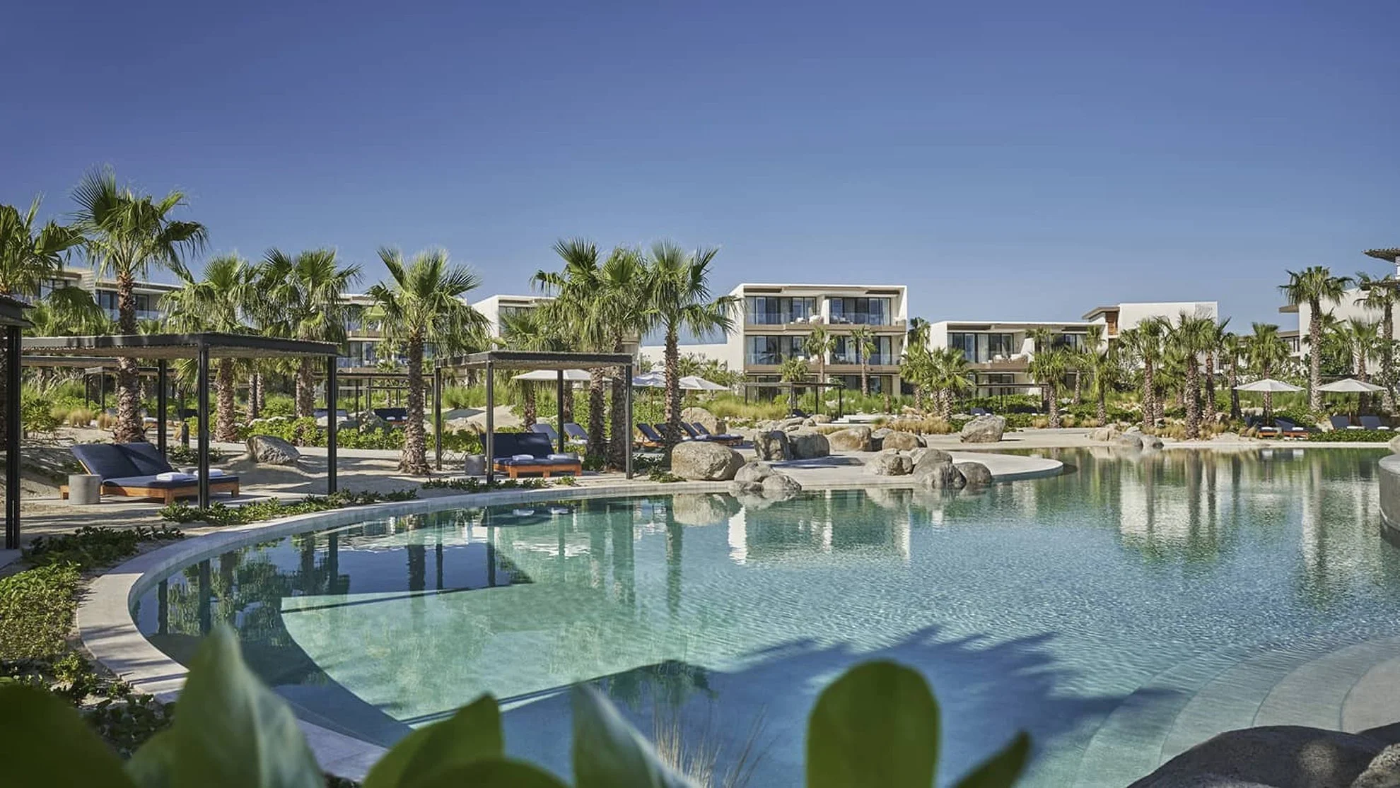 Four Seasons Los Cabos Costa Palmas luxury wedding venue with modern architecture, poolside setting, and lush greenery in Baja California Sur, Mexico
