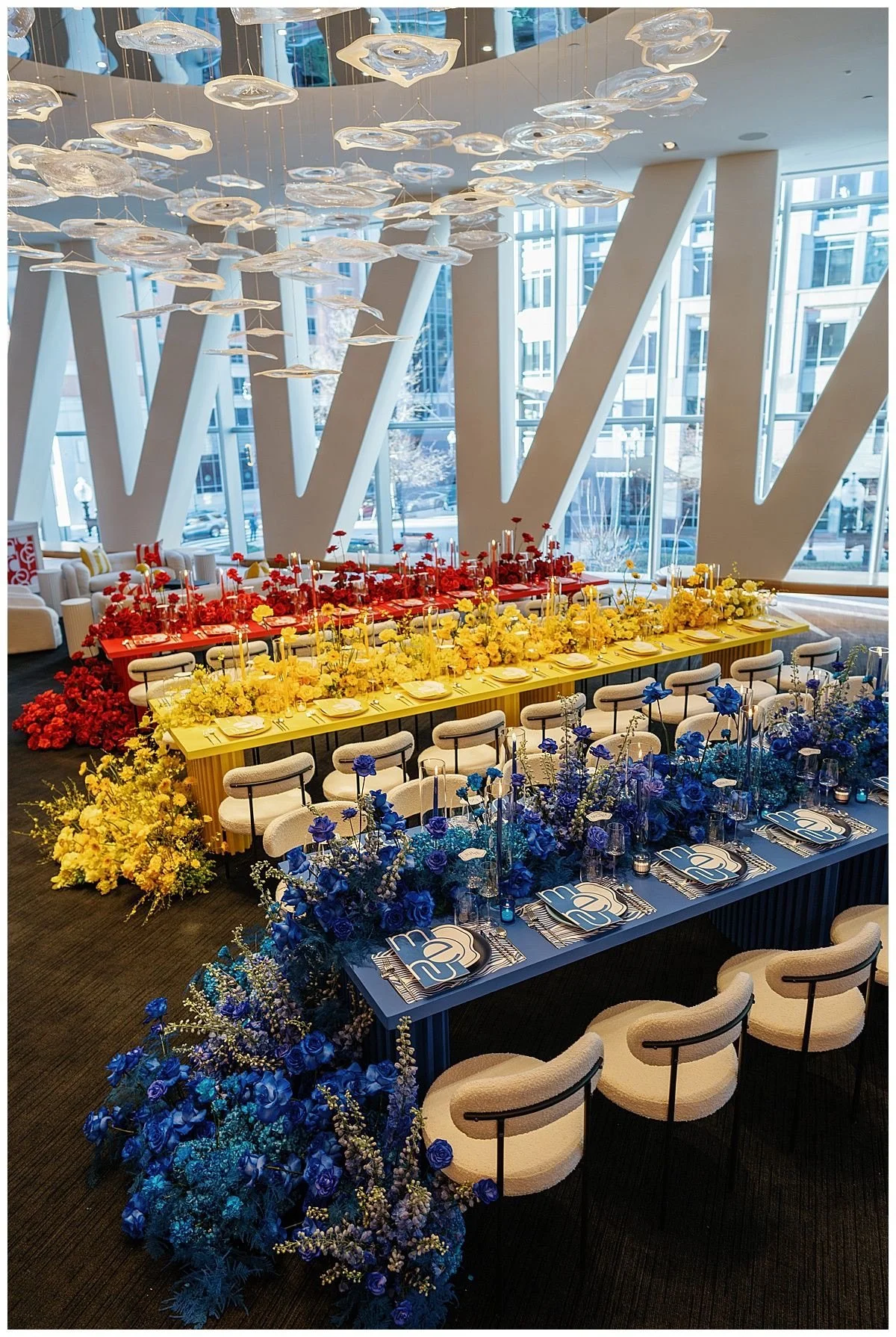 Primary color-blocked tablescape in rooftop industrial event space