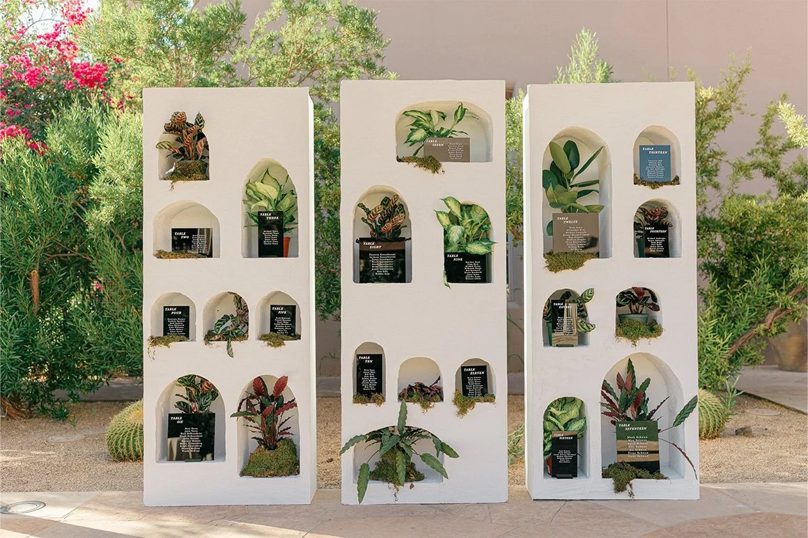Custom plant wall escort card display at outdoor dinner reception at Four Seasons Scottsdale.