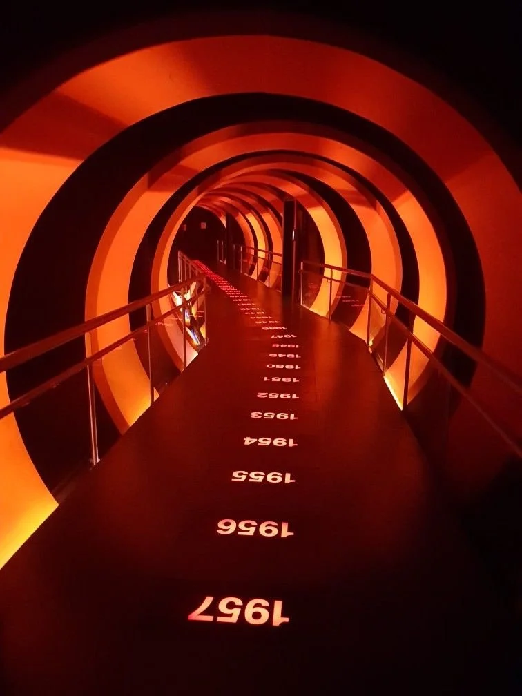 LED-lit timeline entrance under red arches for immersive influencer party