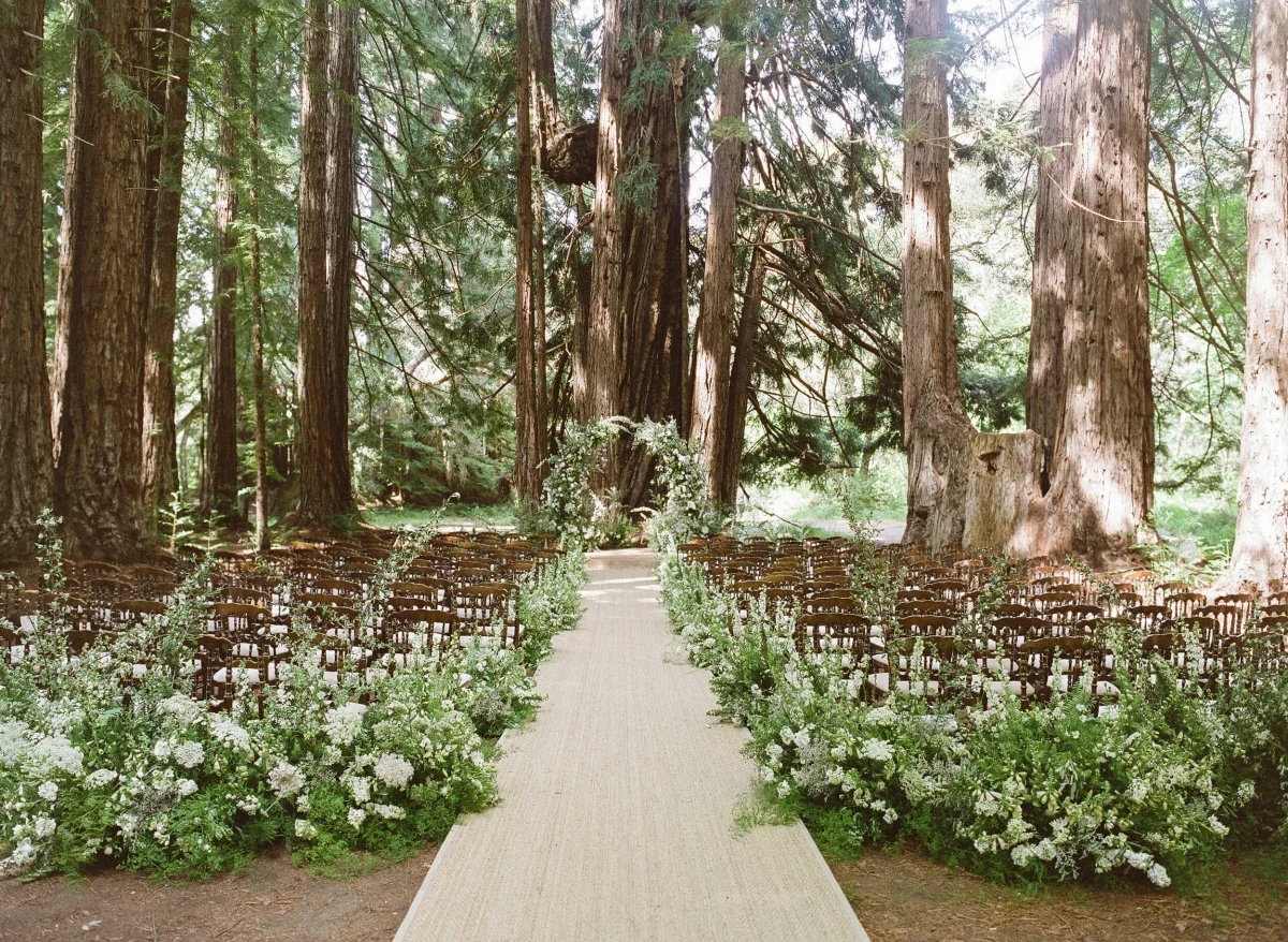 Outdoor wedding ceremony at Santa Lucia Preserve set within a redwood forest with natural surroundings in Carmel, California