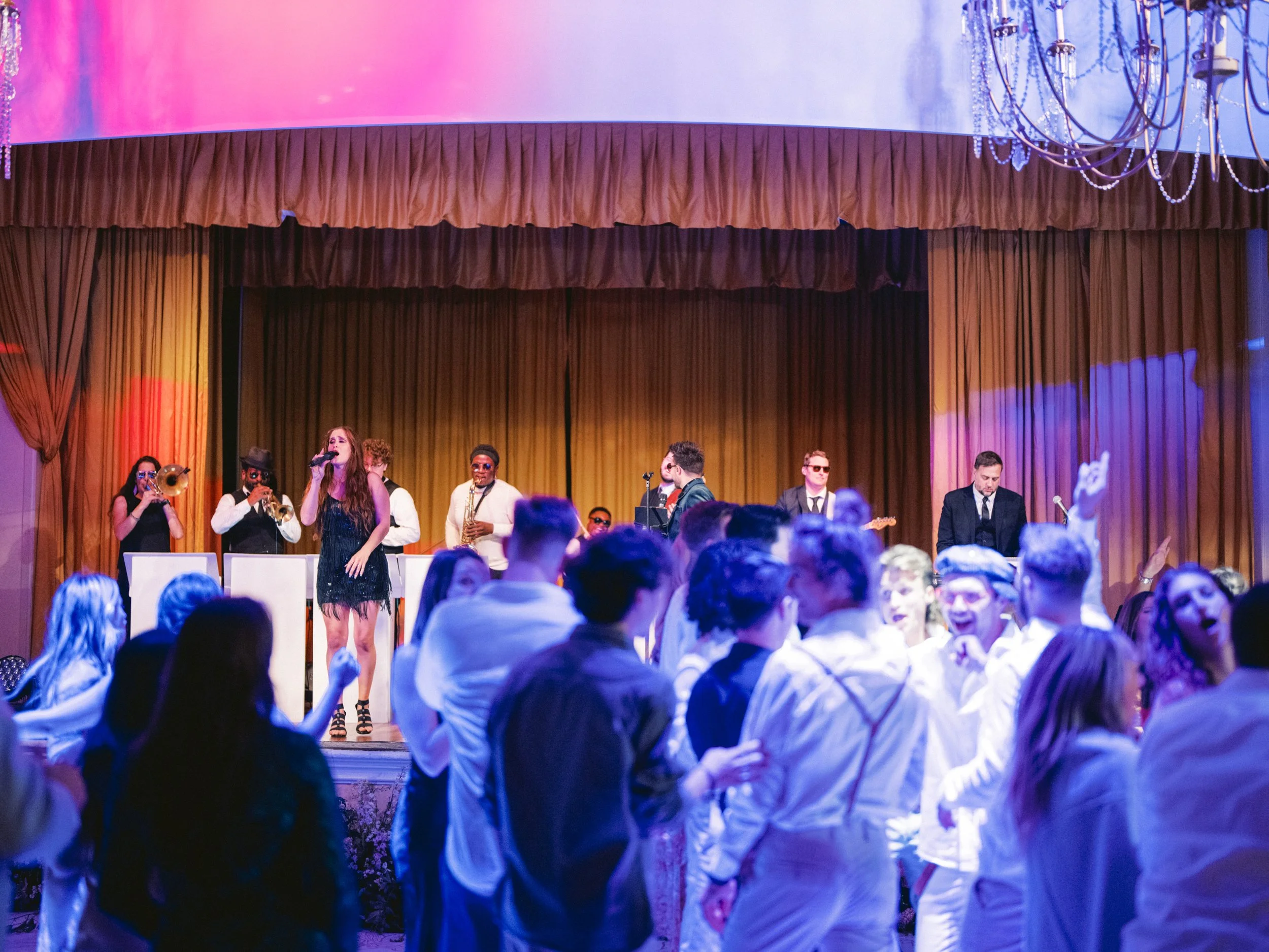 Live band performing at a wedding reception at Hotel del Coronado, creating an energetic and immersive guest experience through live entertainment