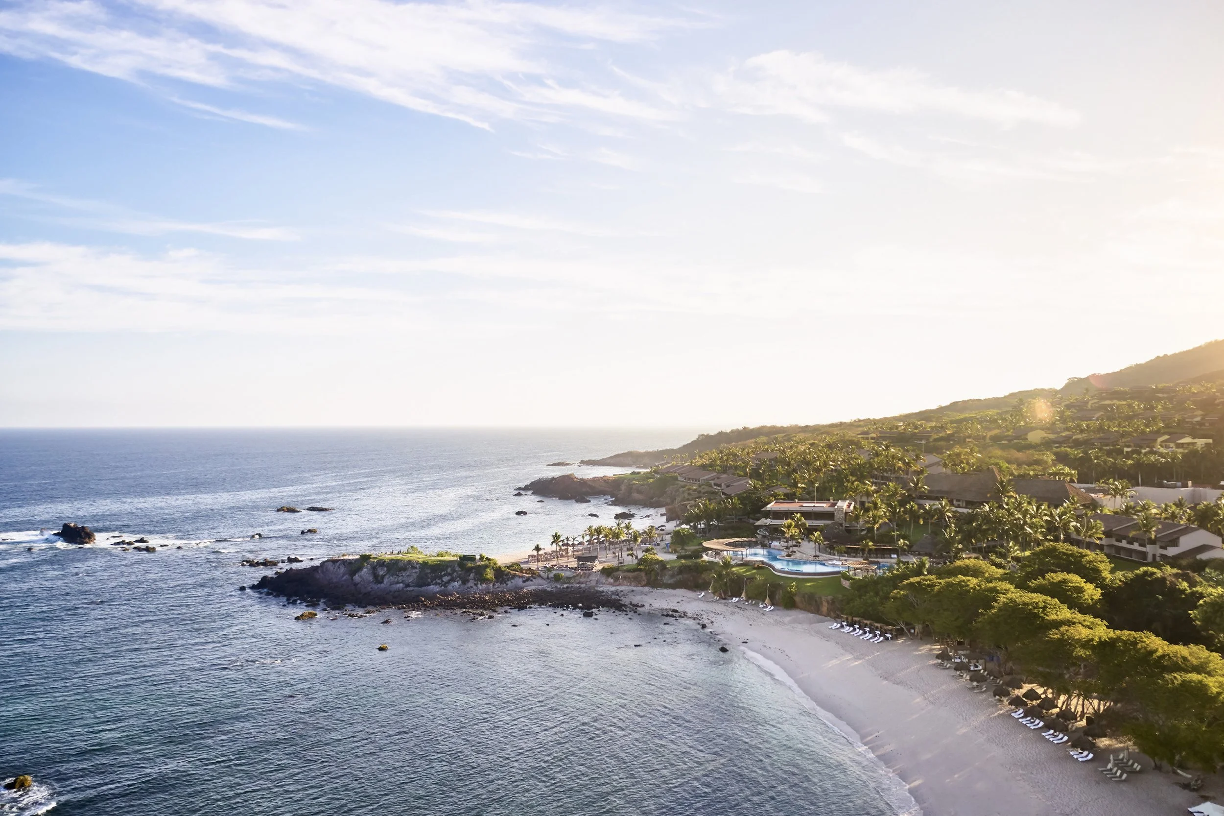 Four Seasons Punta Mita luxury wedding venue with cliffside beach, ocean views, and lush greenery in Riviera Nayarit, Mexico