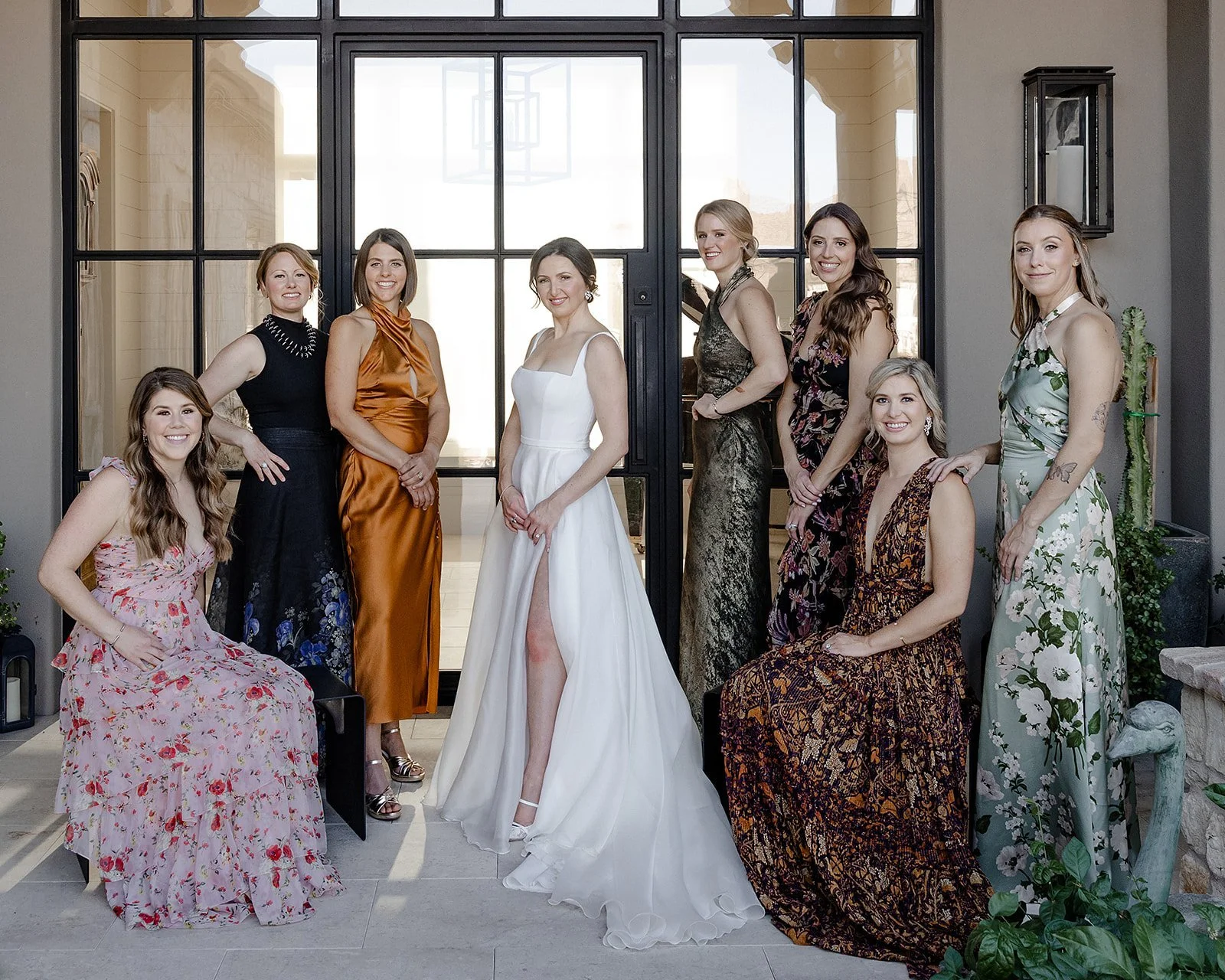 Mismatched bridesmaid dresses in rich jewel tones at Arizona outdoor wedding.