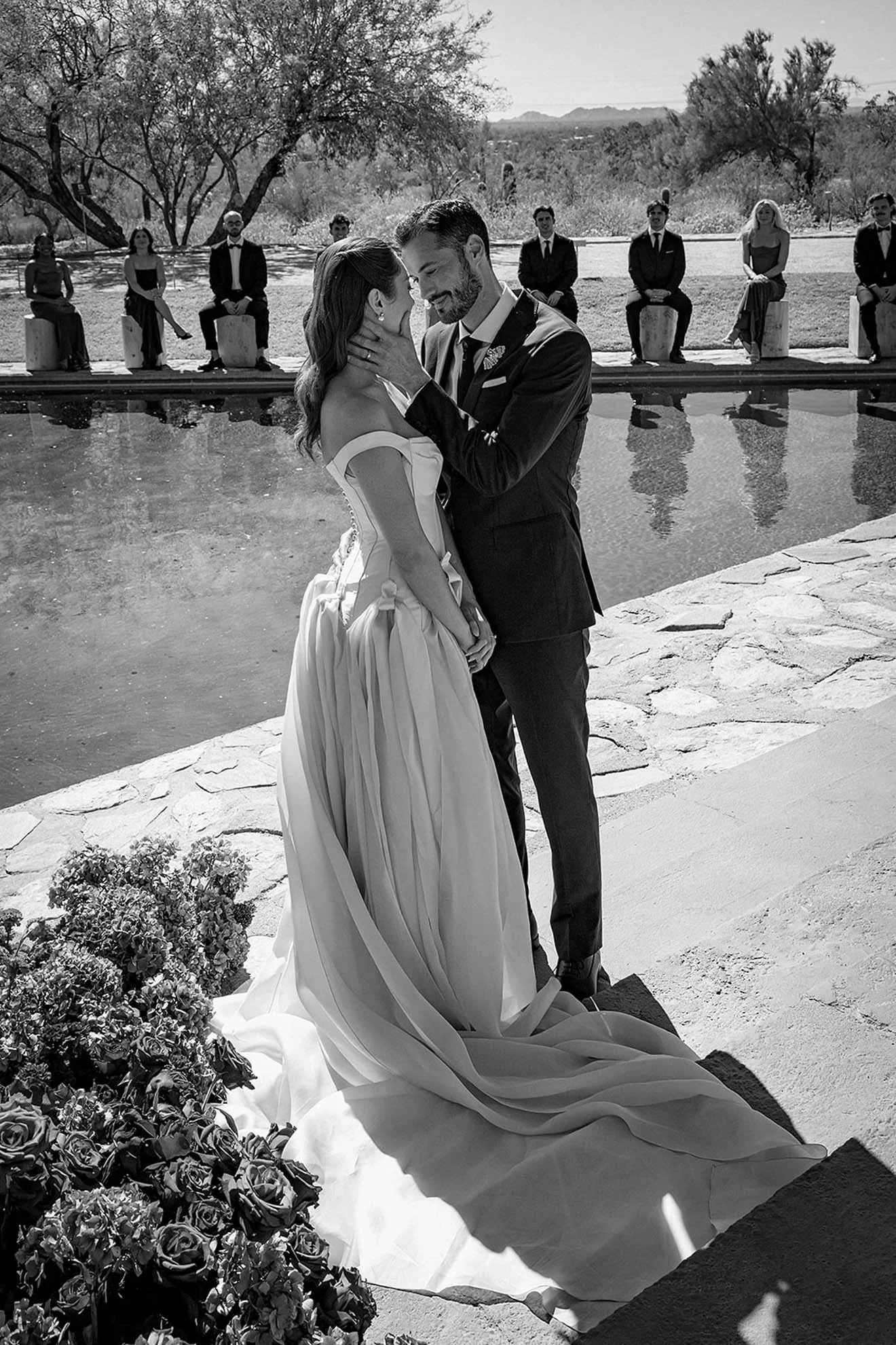 Bride in a J. Andreatta wedding gown at an outdoor ceremony at Taliesin West, a Frank Lloyd Wright property, showcasing a modern and architectural wedding setting