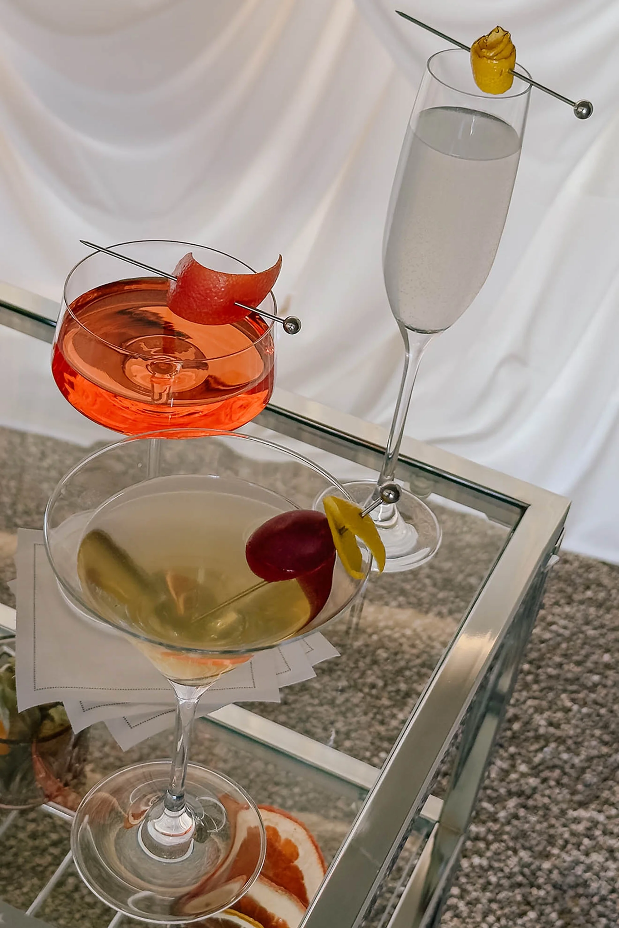 Signature cocktail bar cart with a mixologist serving custom drinks at a luxury wedding welcome party