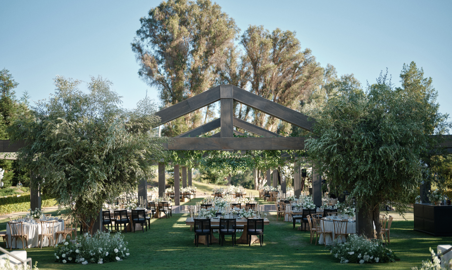 Ojai Valley Inn wedding venue lawn with wooden tented structure set for an outdoor reception in Ojai, California