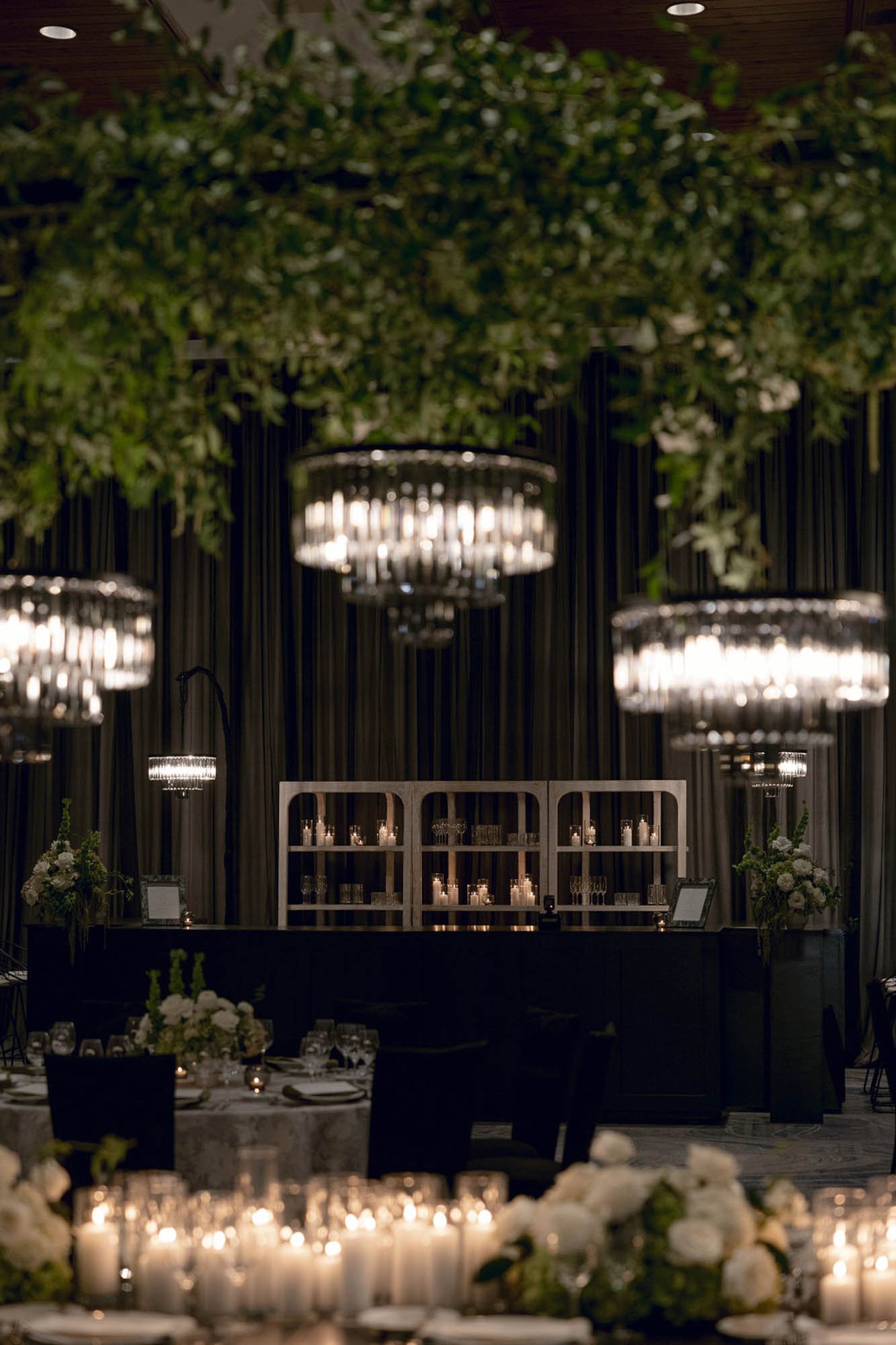 Luxury wedding reception head table and bar with elevated tablescape design, creating an immersive dining experience that blends presentation, flow, and guest interaction