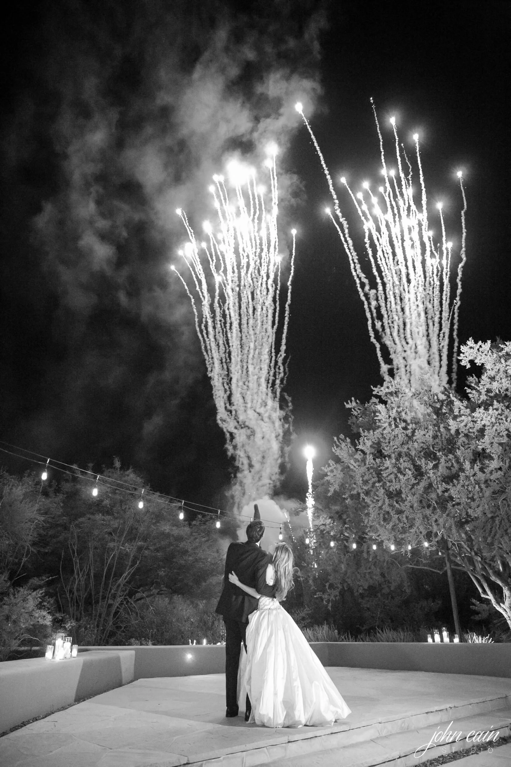 Wedding couple watching fireworks display at Four Seasons Scottsdale on their celebration night.