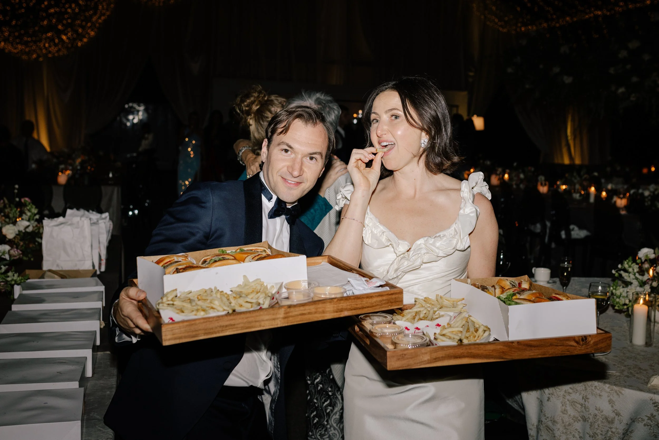 Wedding couple enjoying late-night In-N-Out bites during their Arizona wedding celebration.