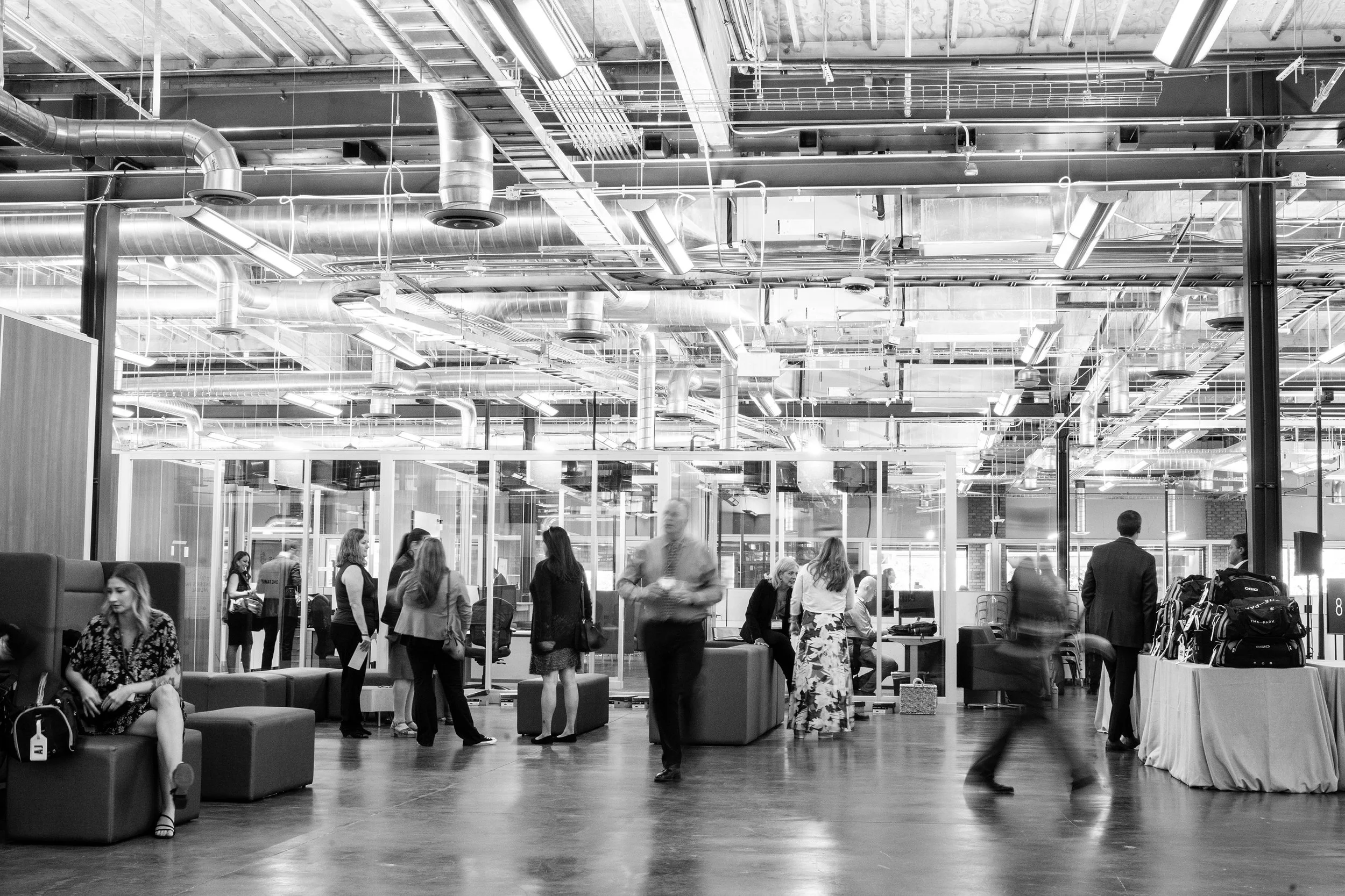 Corporate conference attendees moving through the event space with energy and purpose, showcasing dynamic networking and seamless event flow planned by Mandy Marie Events.