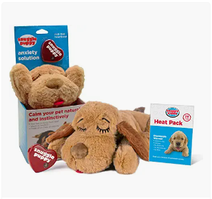 Two plush toys resembling a dog and a rabbit, along with anxiety relief products including a heat pack and a calming solution for pets.