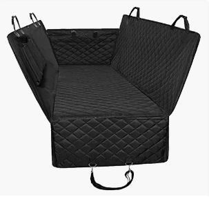 Open black quilted suitcase with compartments and straps inside.