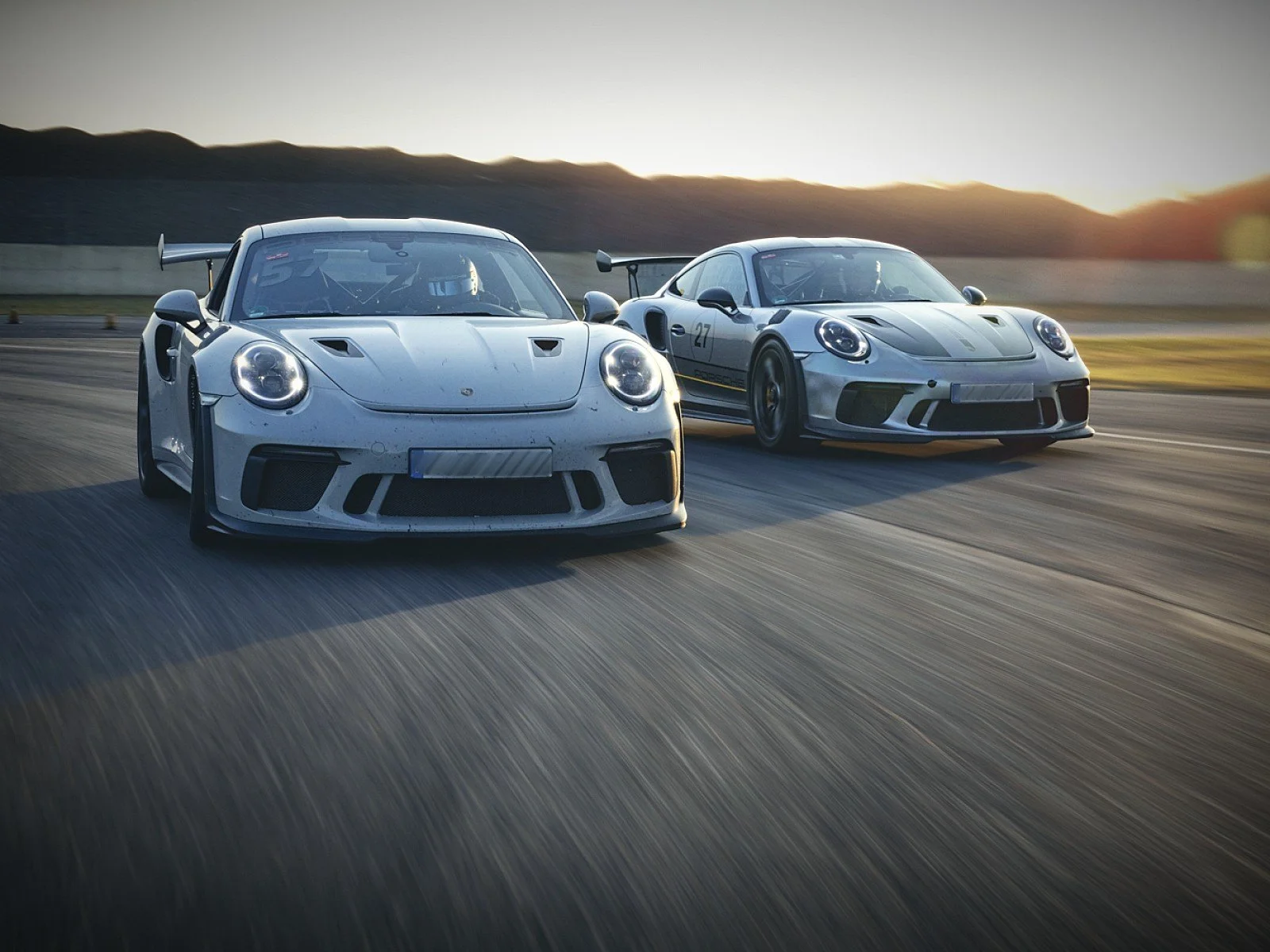 Two Porsche GT3 on track at a driver development day