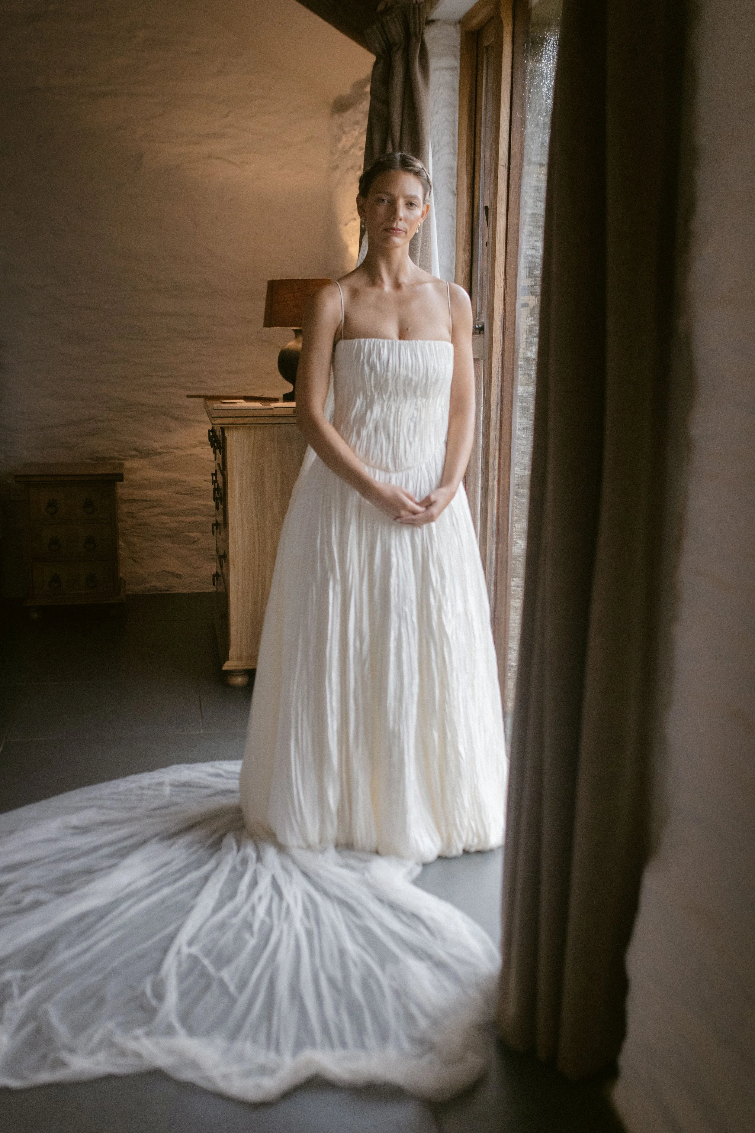 bride wears danielle frankel for a rainy summer wedding at roscarrock wedding venue in cornwall