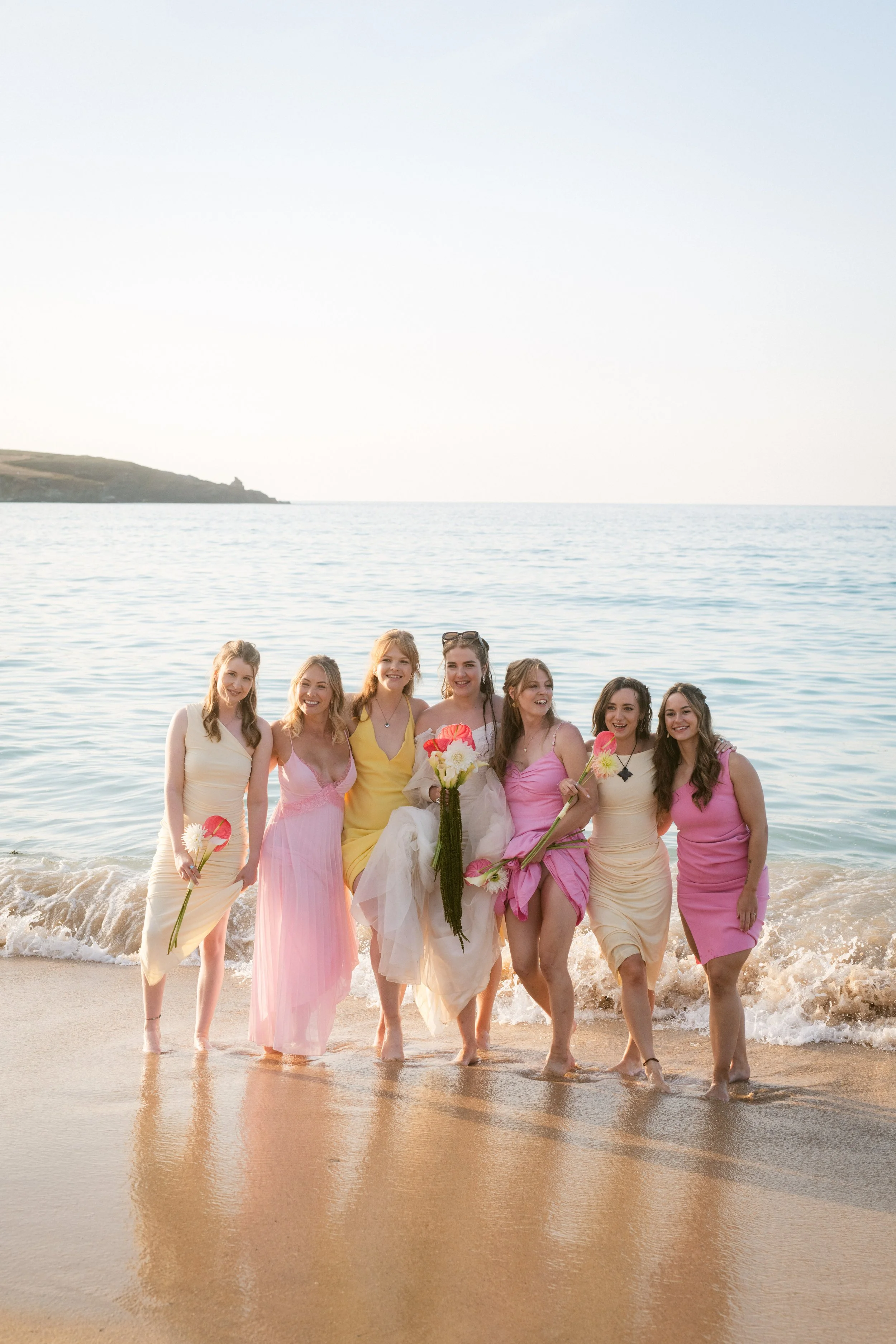 bridesmaids in pink and yellow for colourful beach wedding