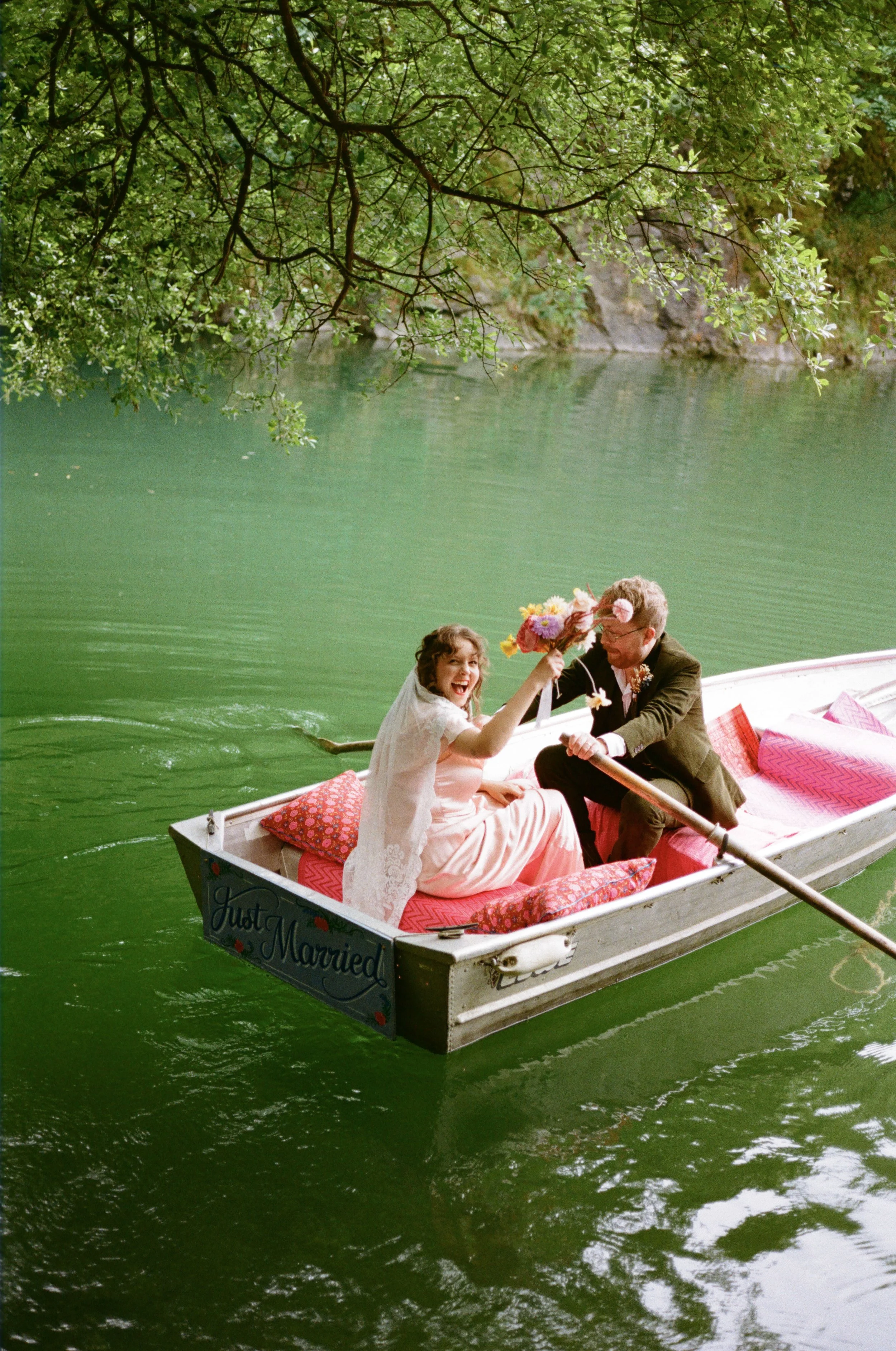 turquoise lakeside wedding ceremony at the Cornish tipi weddings venue with a bride in a pink vintage dress captured on film
