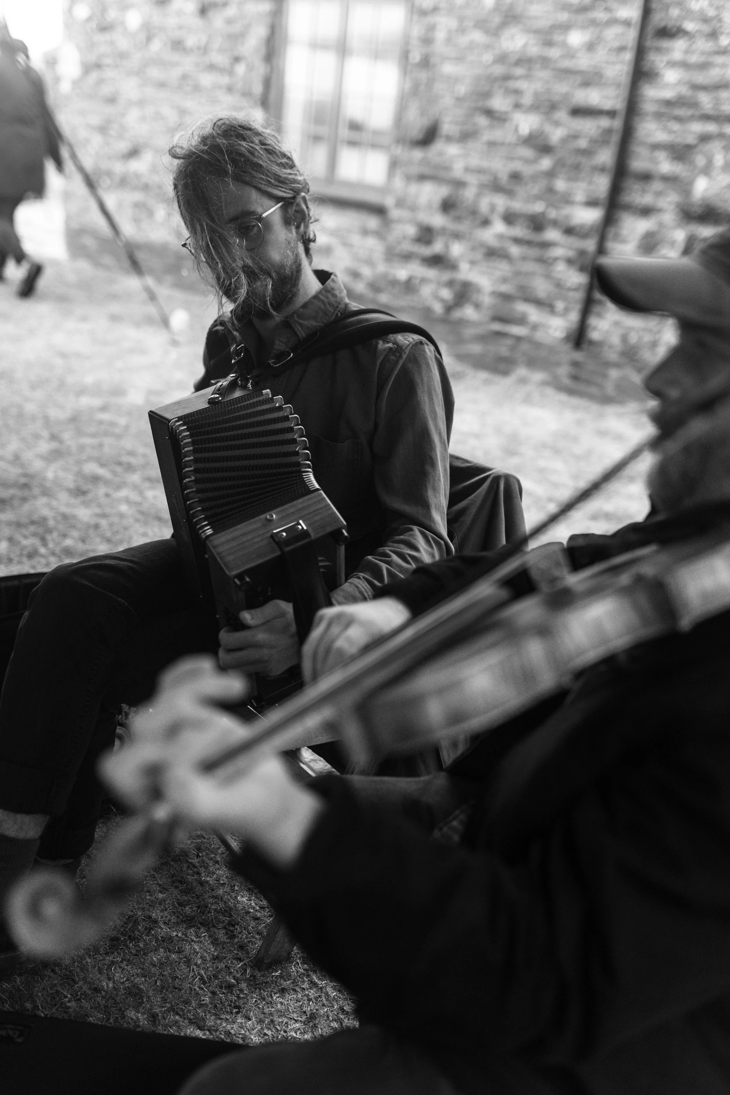 accordion folk musician at a cornish outdoor wedding in the summer