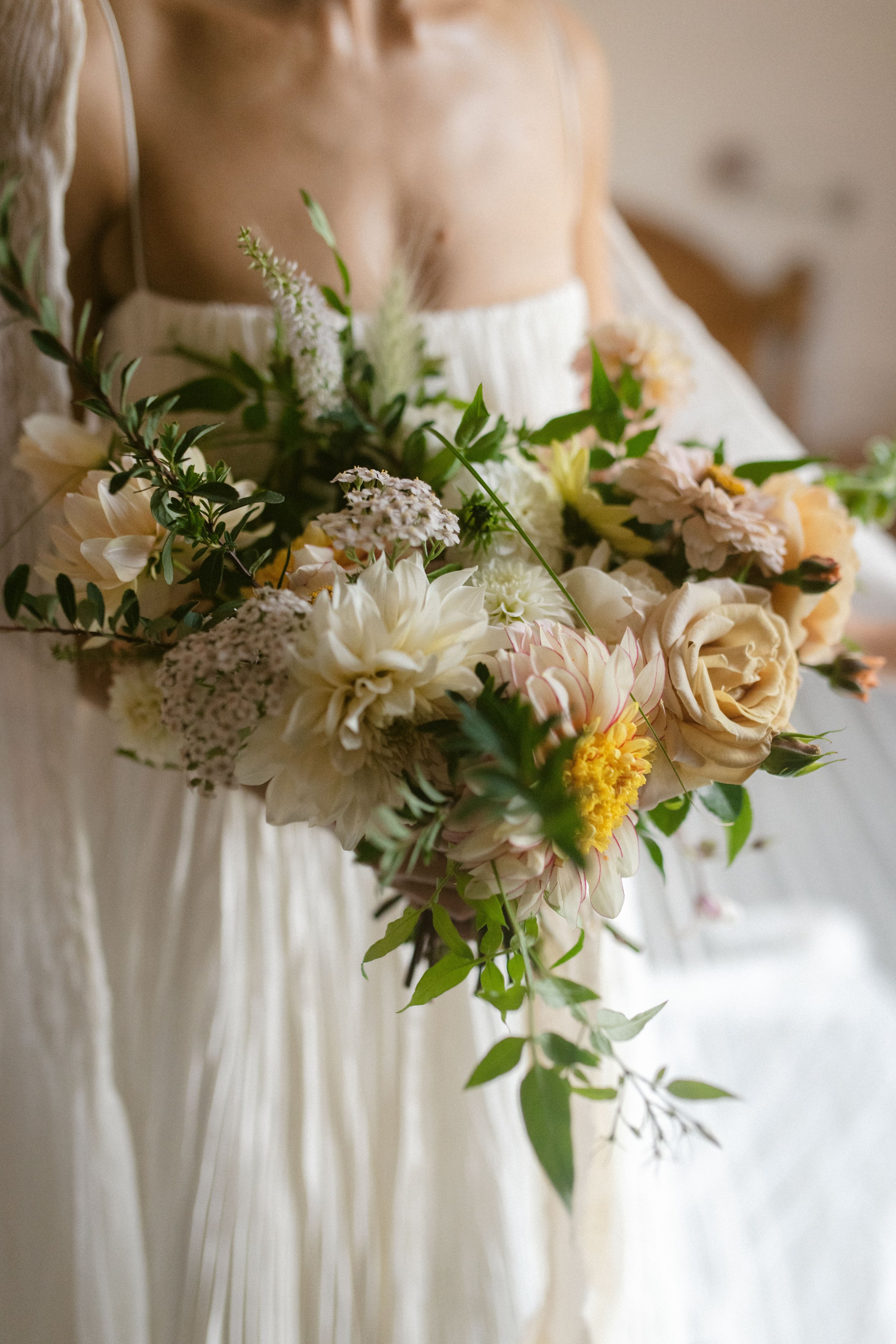 elegant summer wedding inspiration with dahlia and wildflower bouquet in the southwest by the sea