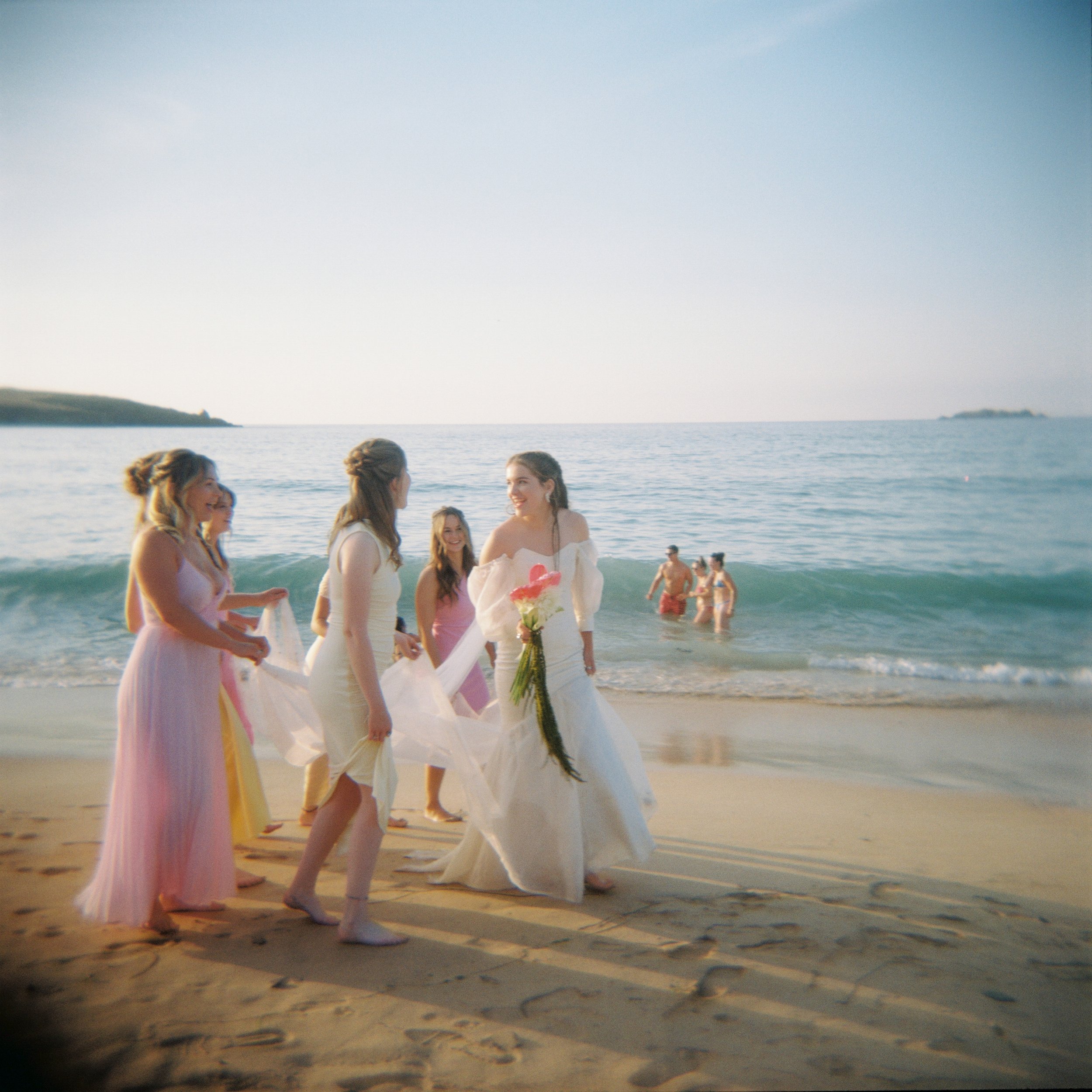 wedding photography captured on holga with the ocean in the background and bride wearing her mothers vintage wedding dress