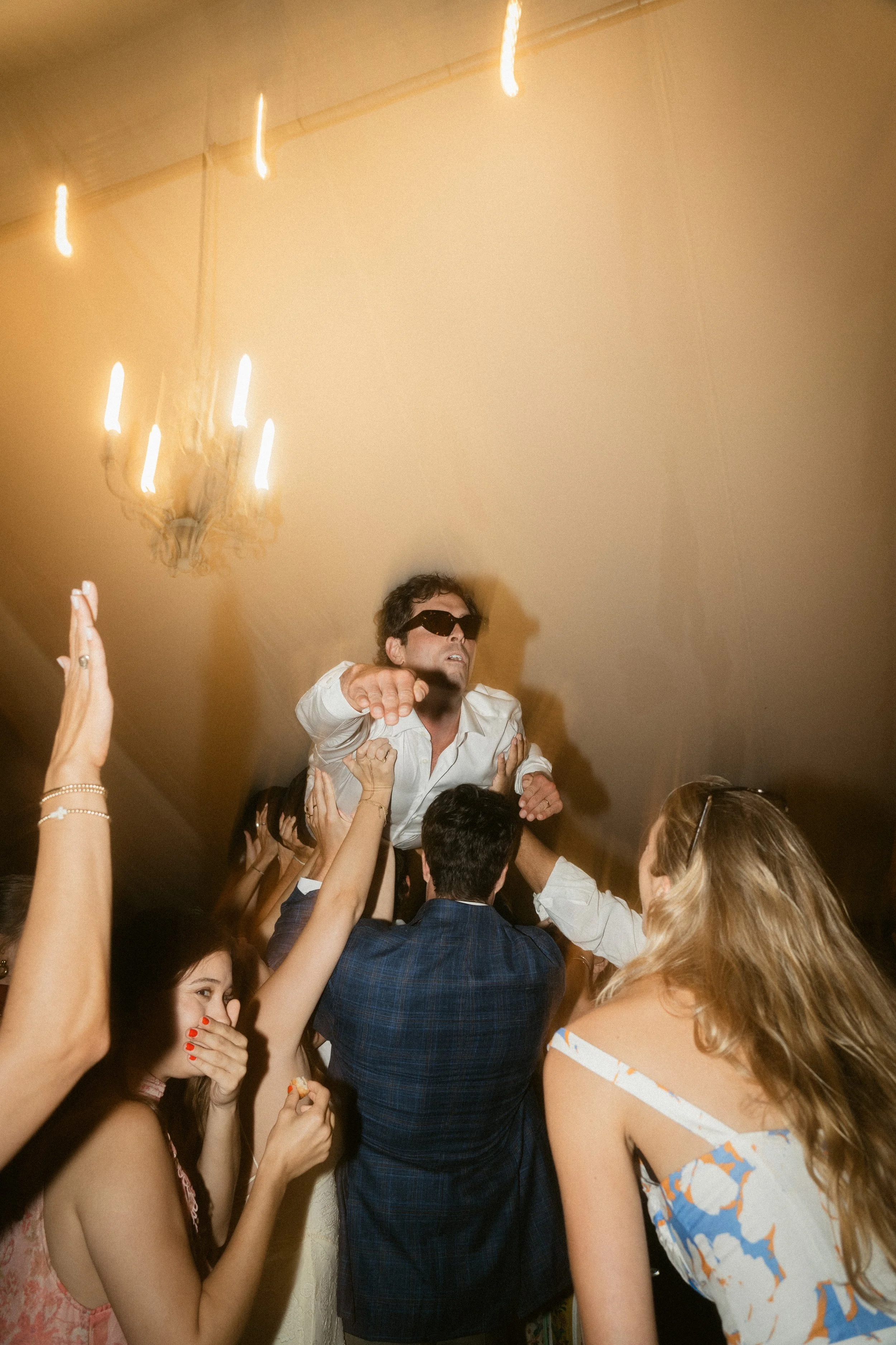 groom crowdsurfs at a summer wedding at roscarrock manor farm