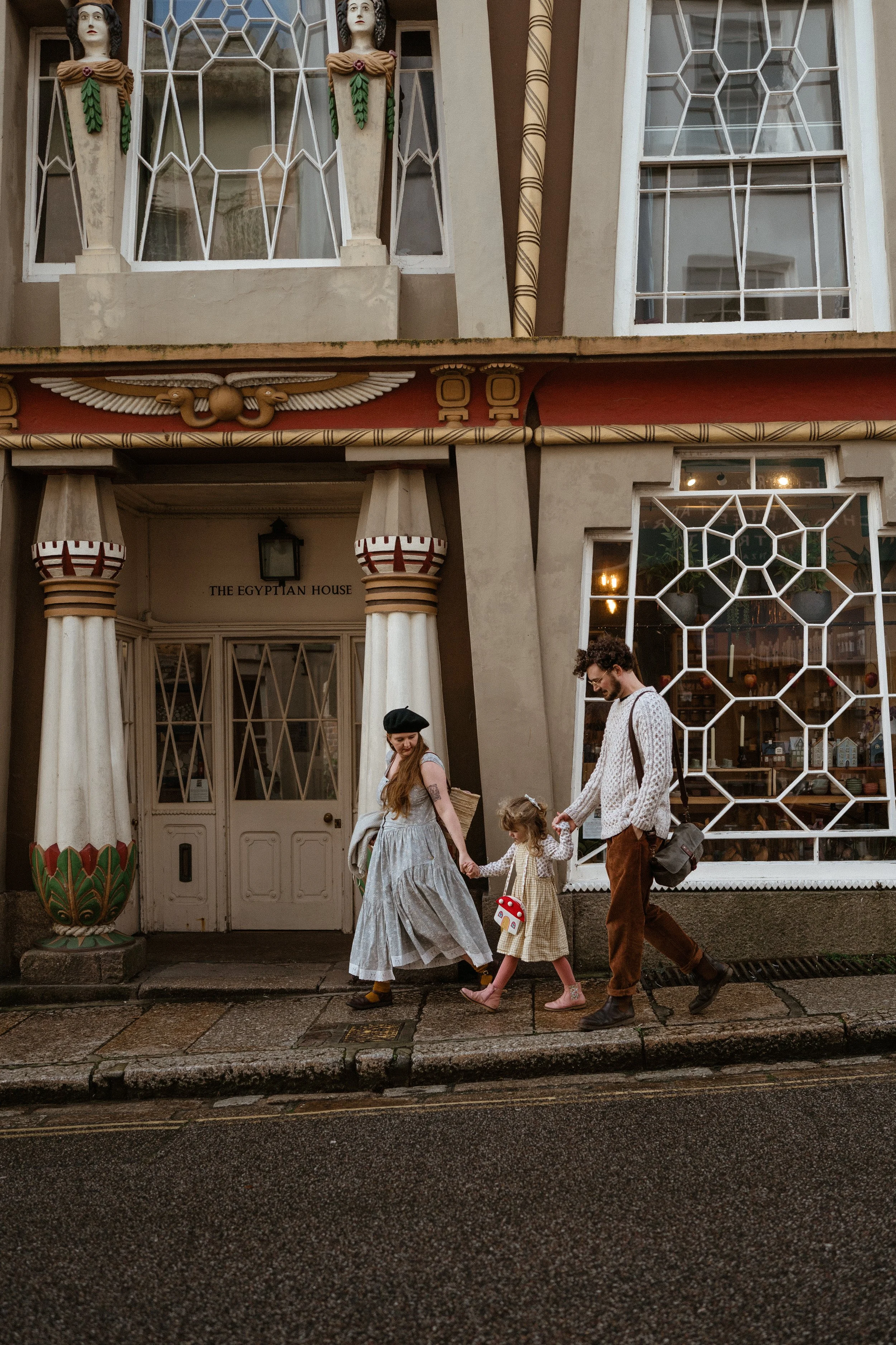quirky and alternative southwest wedding photography and videography walking outside the egyptian house on Chapel street Penzance