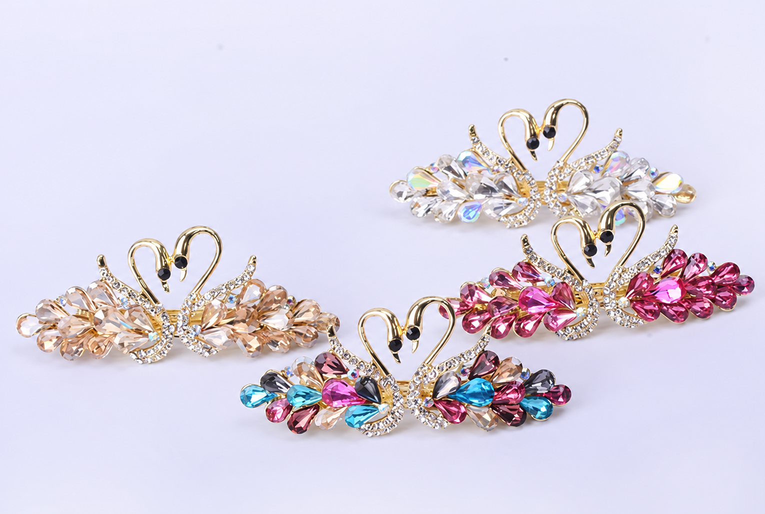 Four crystal swan clips on lavender.png