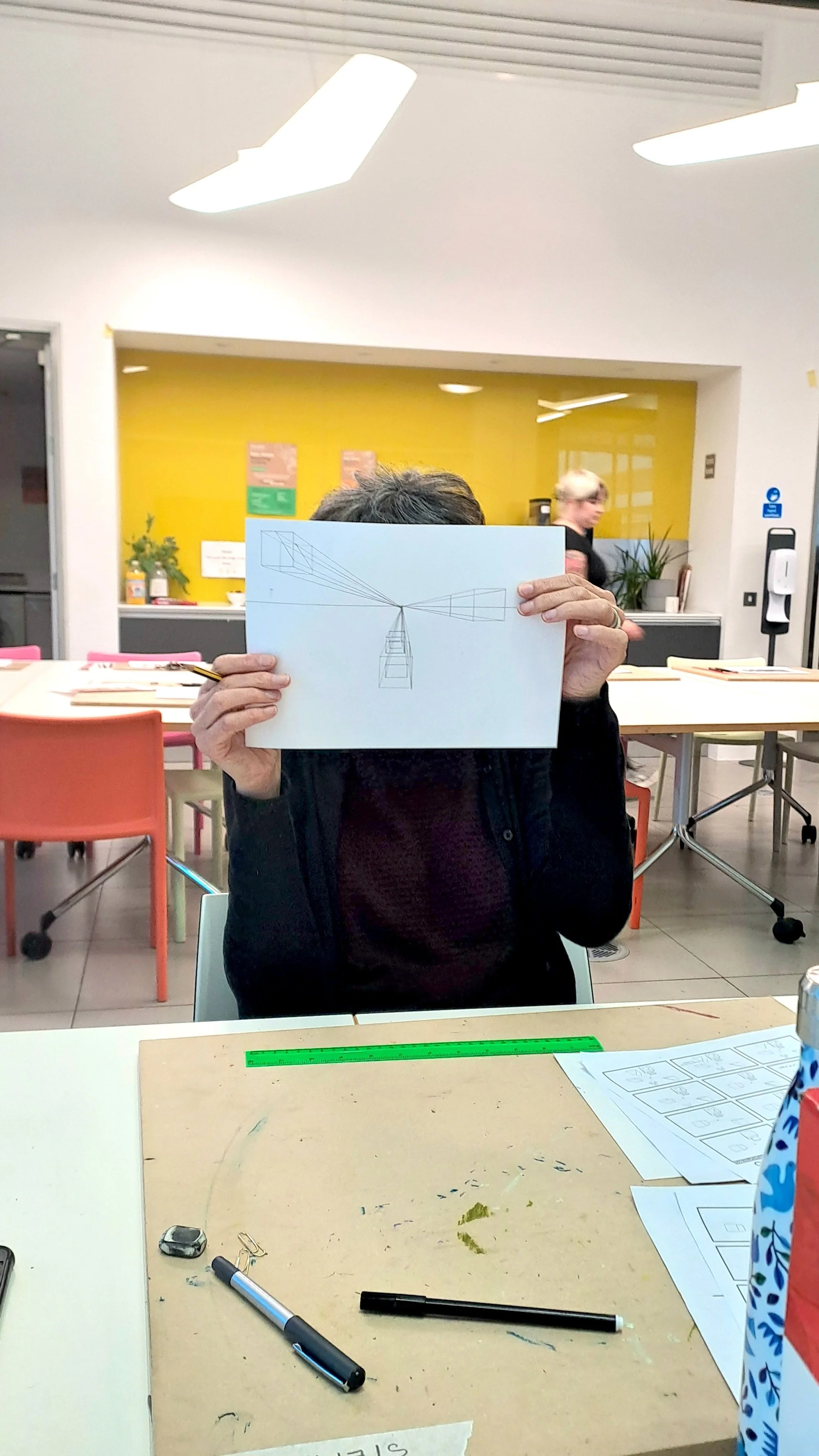 A participant showing their perspective drawing.