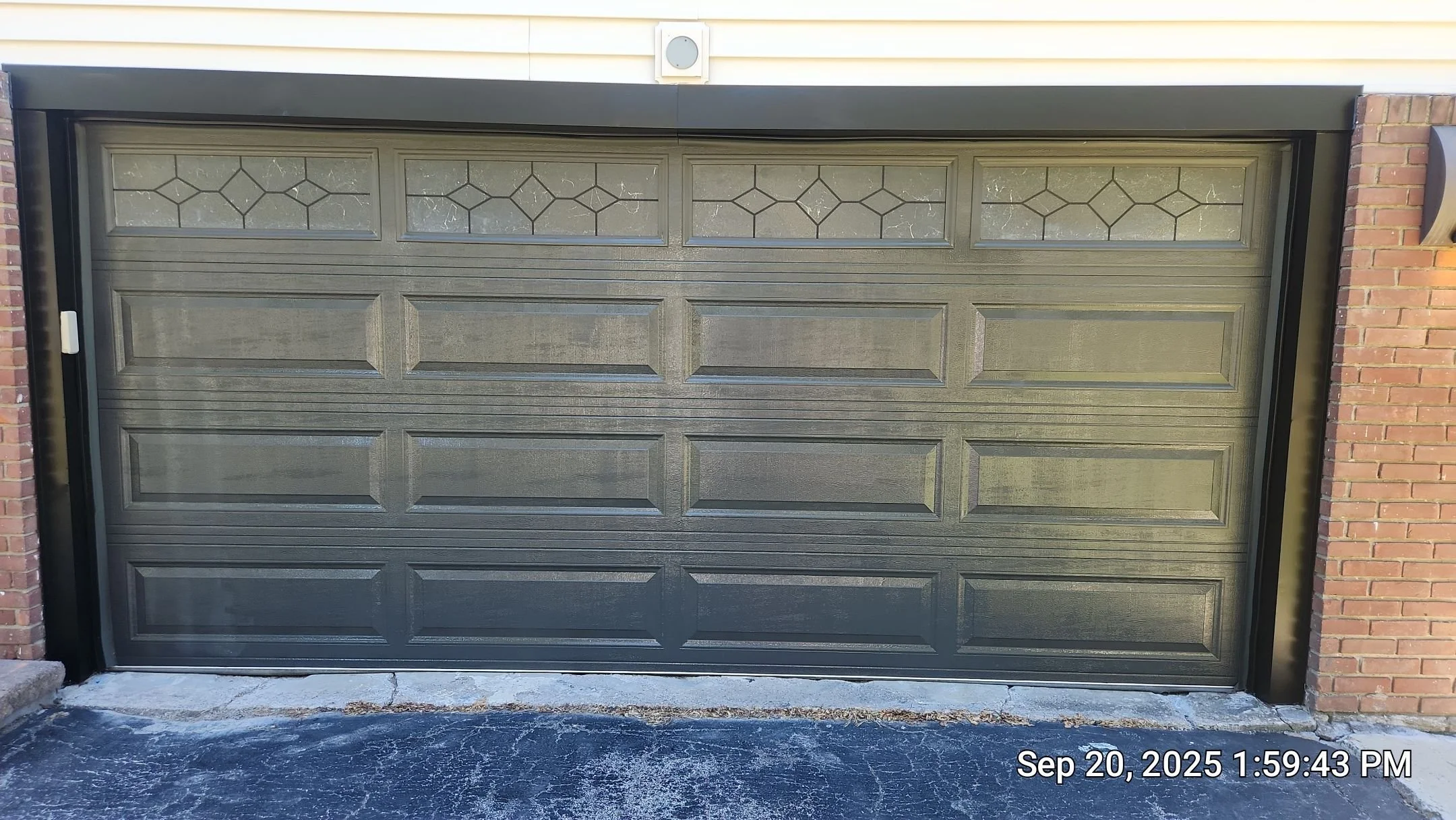 Modern Transformation: Brighton, NY Iron Ore Garage Refinish A stunning exterior upgrade featuring a flawless spray finish on this multi-panel garage door. Using Sherwin-Williams Latitude Exterior Acrylic in a sophisticated Satin sheen, we achieved a