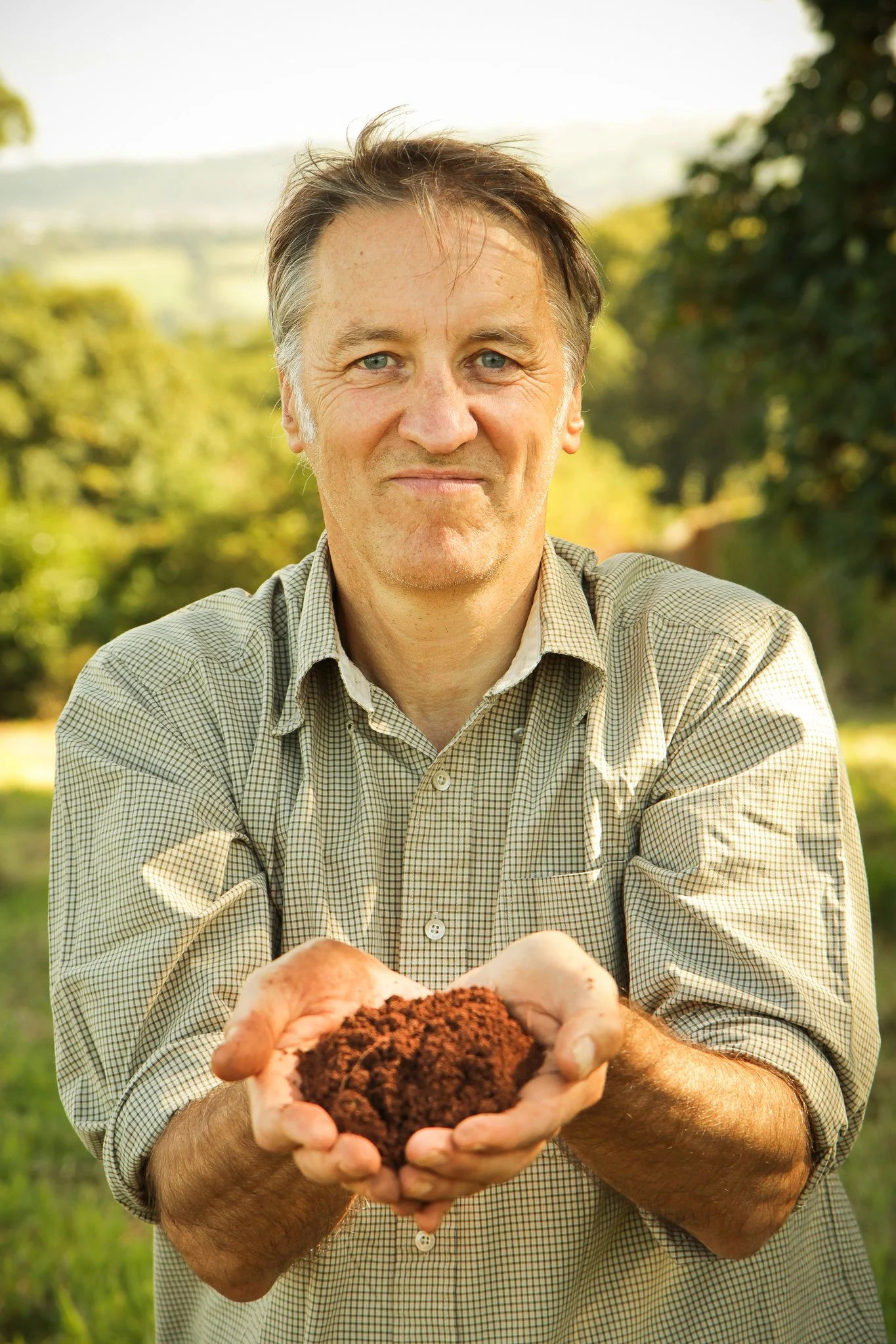 Phil with handful of soil.jpg