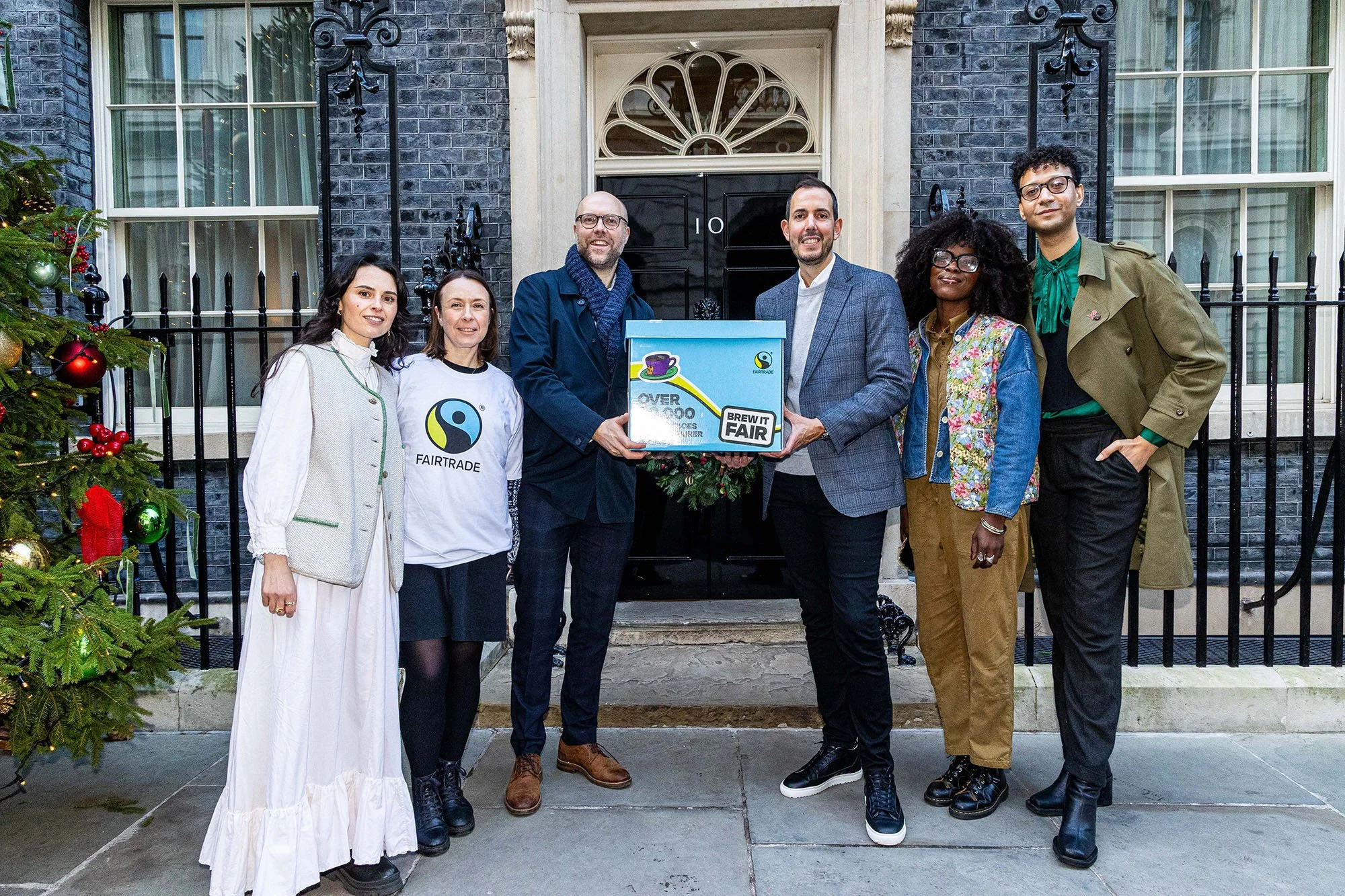 Fairtrade Foundation and Clipper Tea representatives standing outside Downing Street