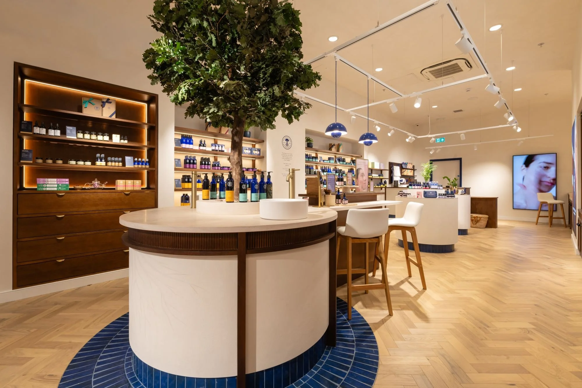 Interior of Neal's Yard Remedies in Manchester featuring a large indoor tree