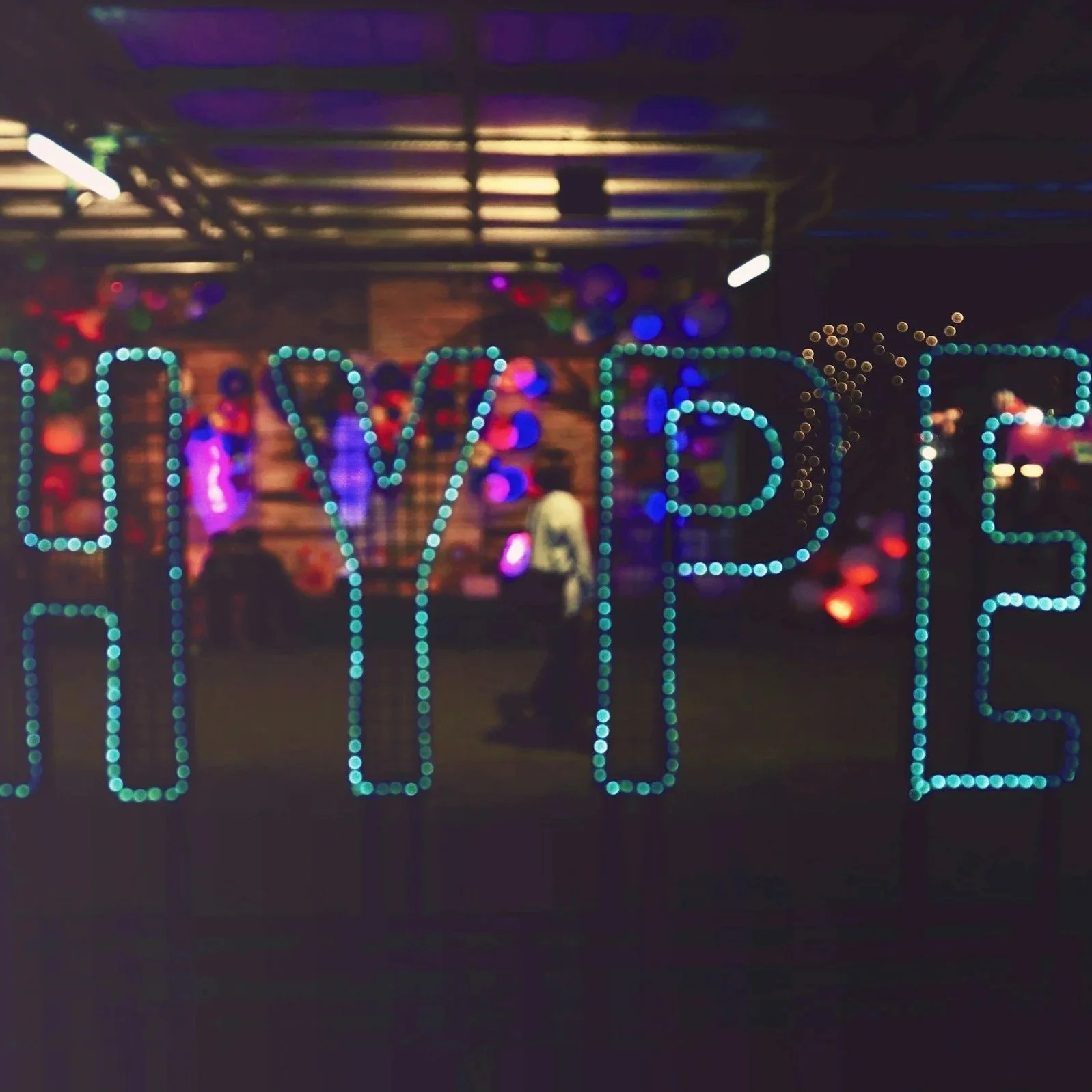 The word hype in blue LED lights with a blurred night time background