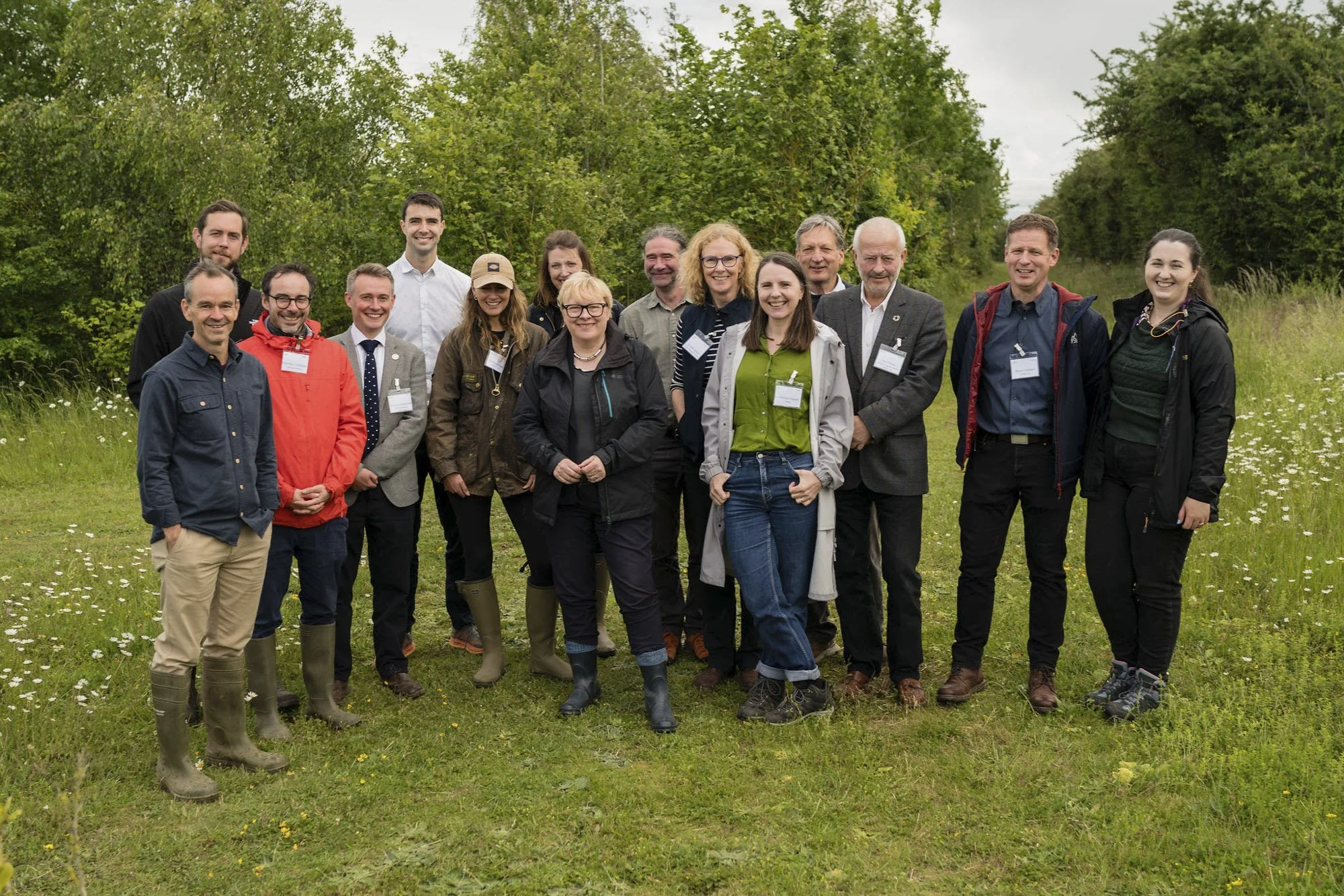 Dame Angela Eagle in a field with farmers, and representatives from organic businesses and organizations.
