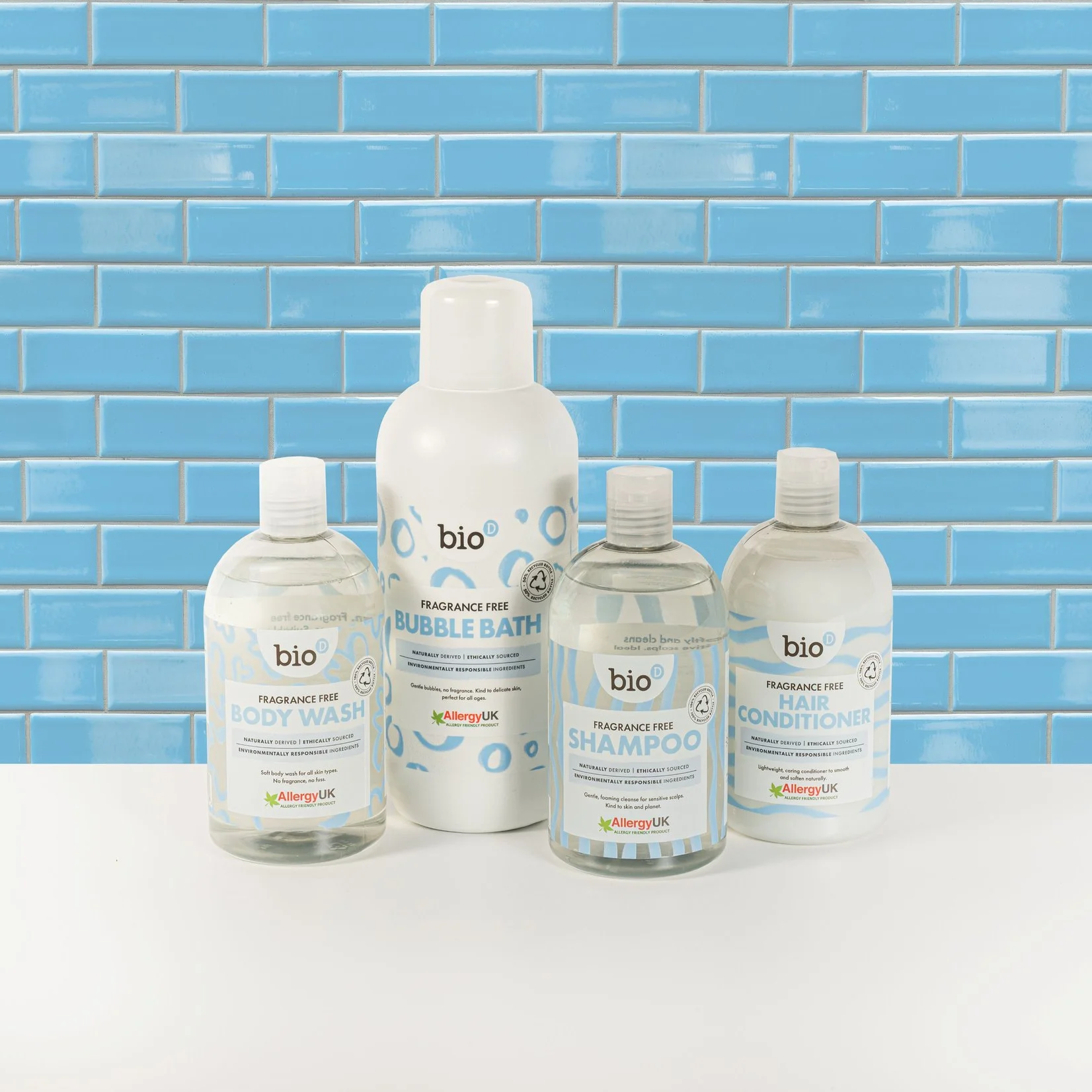 A selection of Bio-D personal care products outlined against a baby blue bathroom wall.