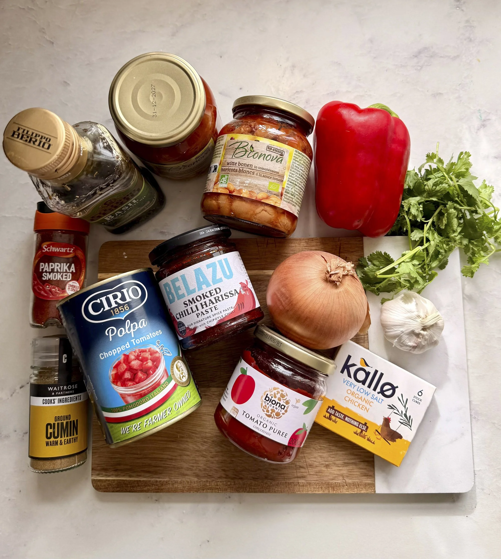 Ingredients for bean soup laid on a board.