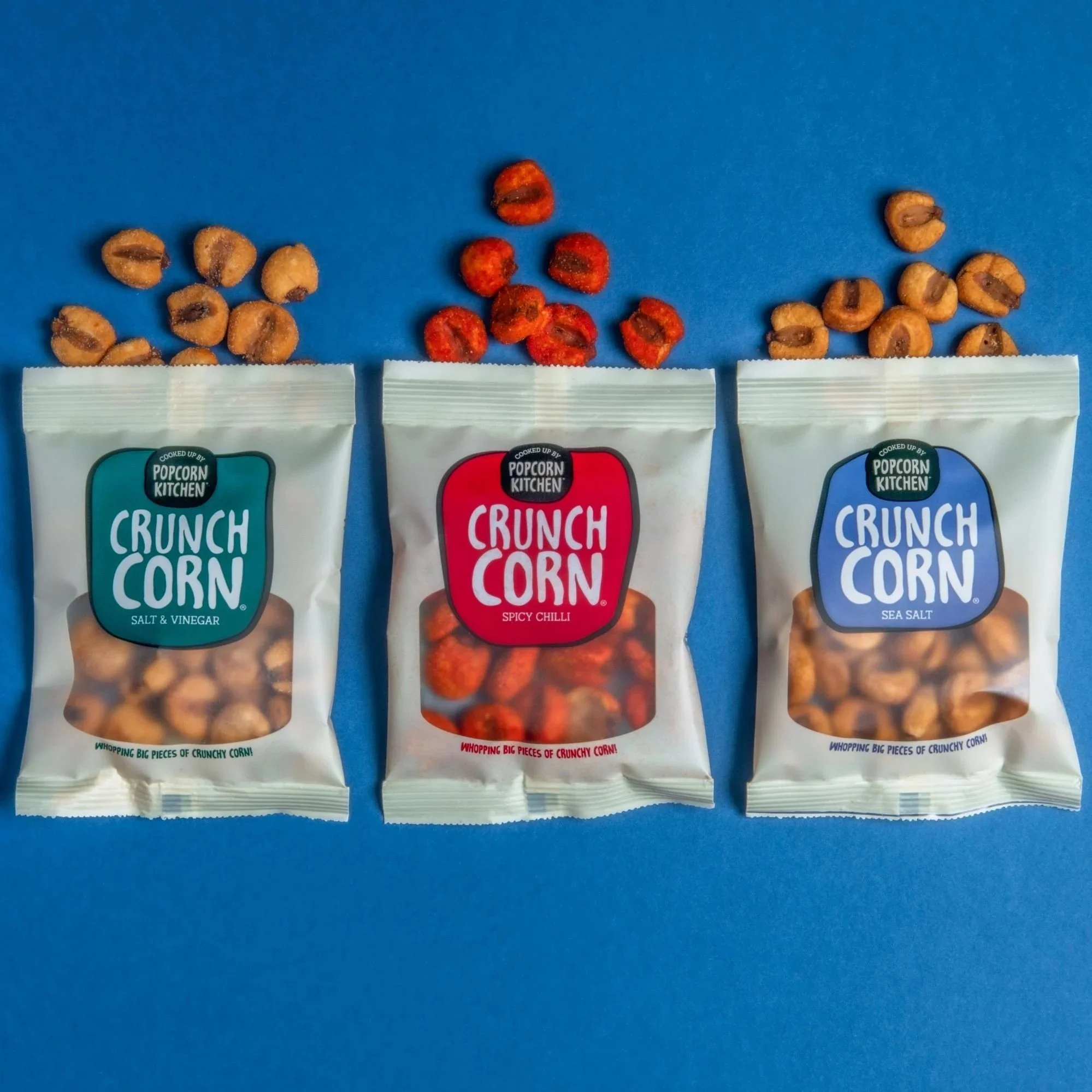 Three packs of Crunch Corn against a blue background.