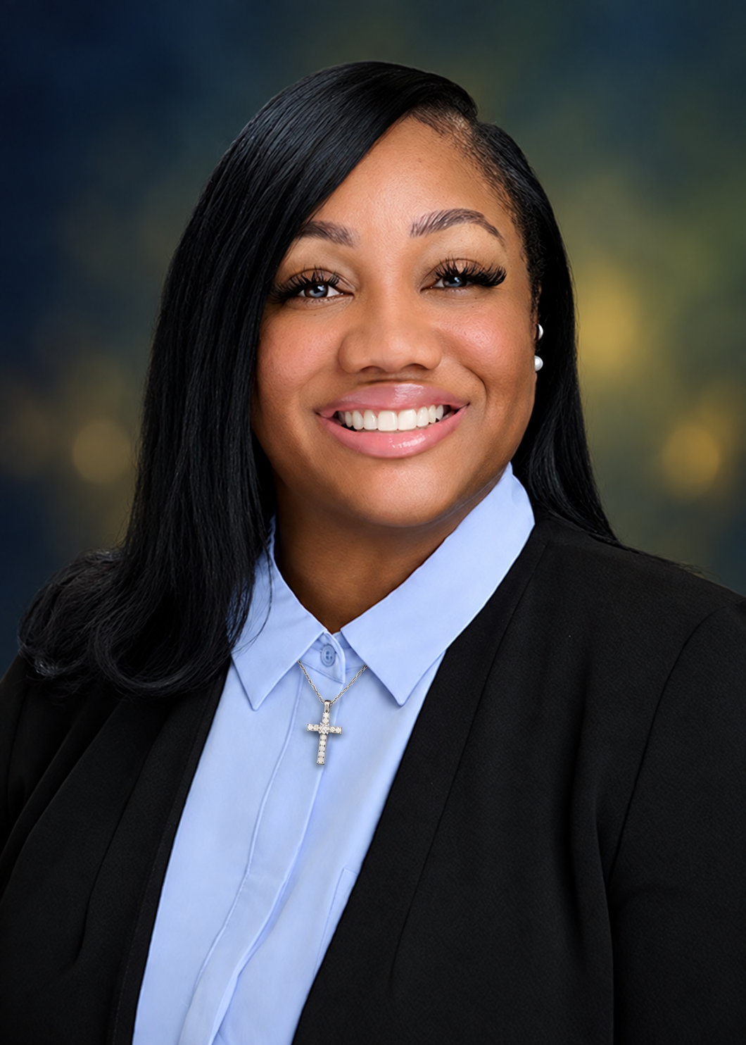 First Lady Latara Newman wearing professional attire and a cross necklace.