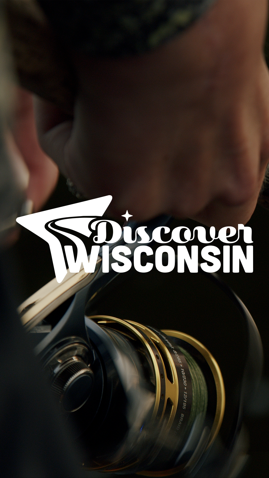Close-up of a person with a fishing reel, with the Discover Wisconsin logo overlayed.