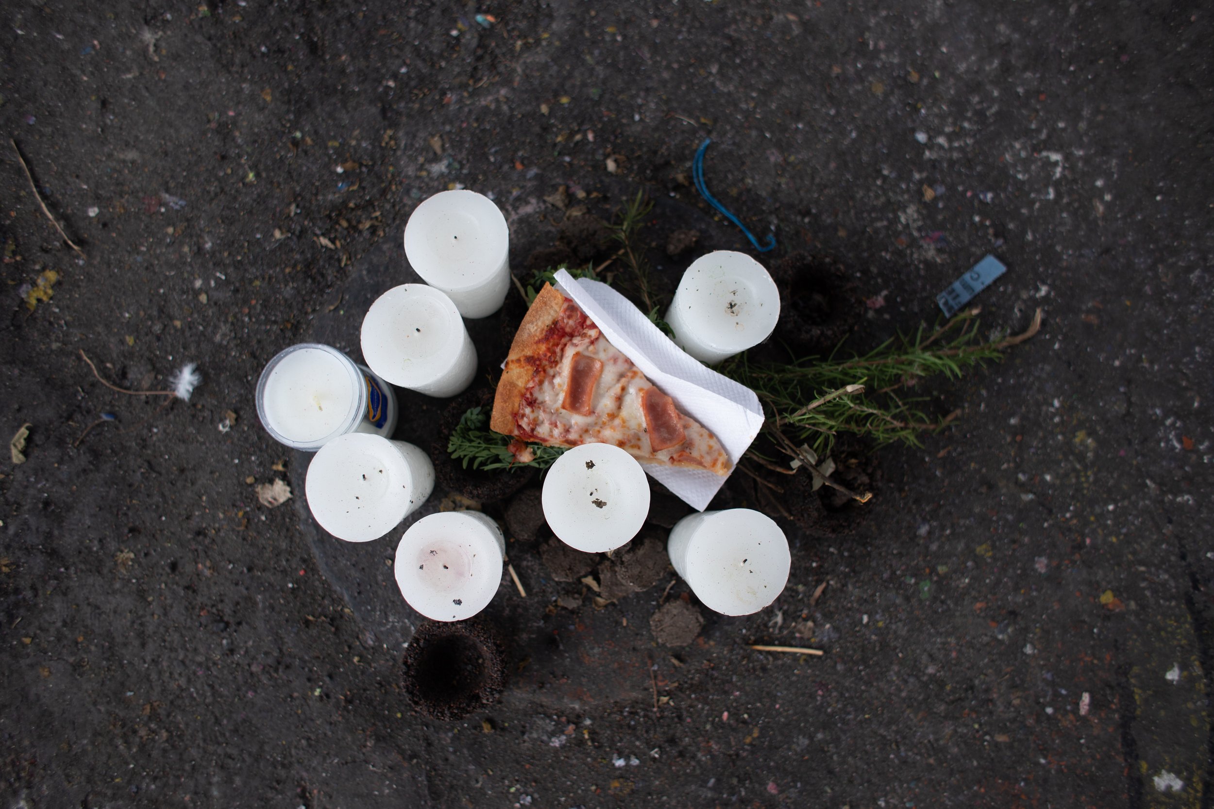 A modest crowd announced in unison, “Here with us” with the enunciation of each of the 41 names. New crosses for the girls were laid out and the once-cracked plaque commemorating their lives was sealed over the flames.
