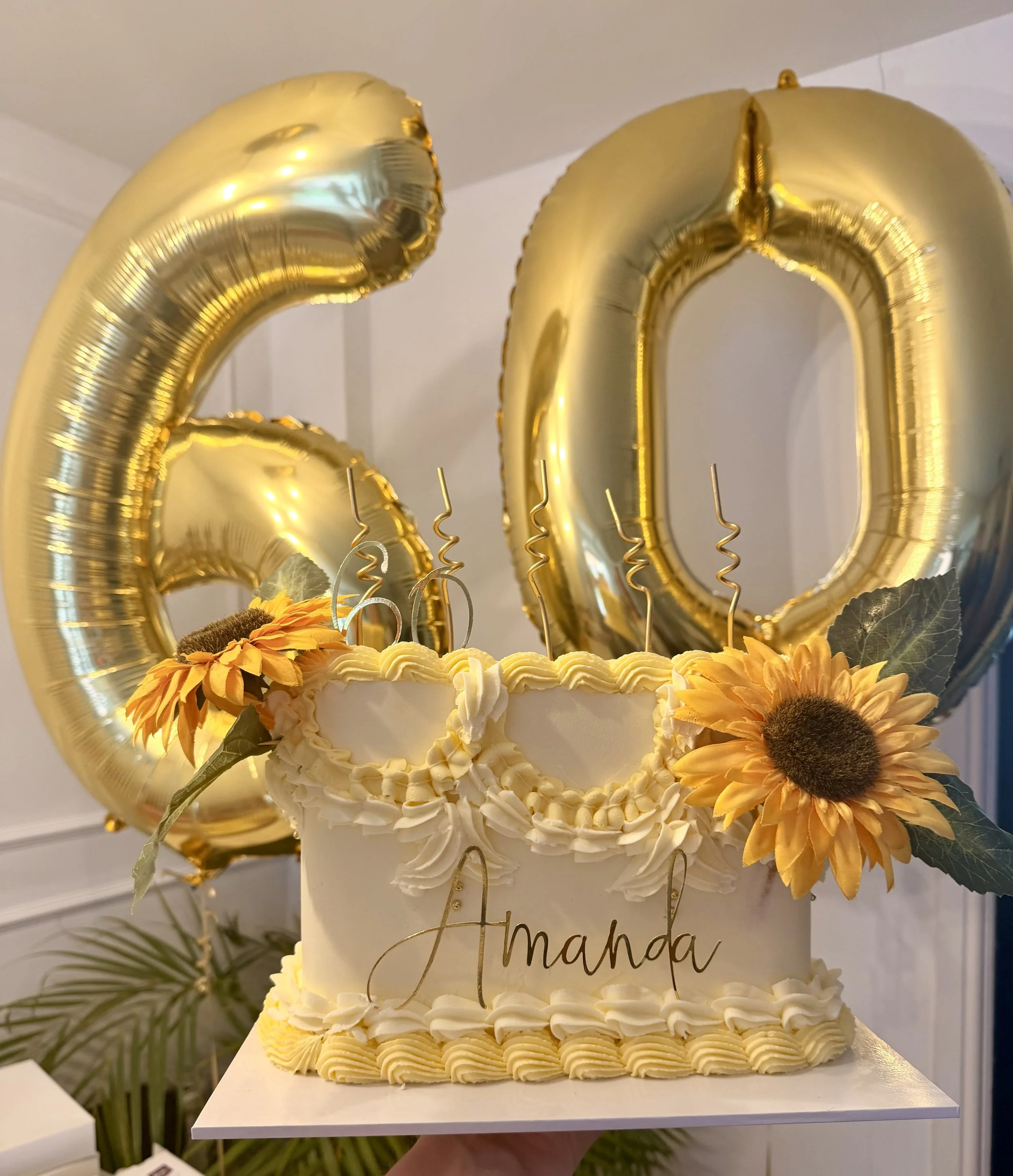 60th birthday cake with yellow buttercream piping, sunflowers and personalised name