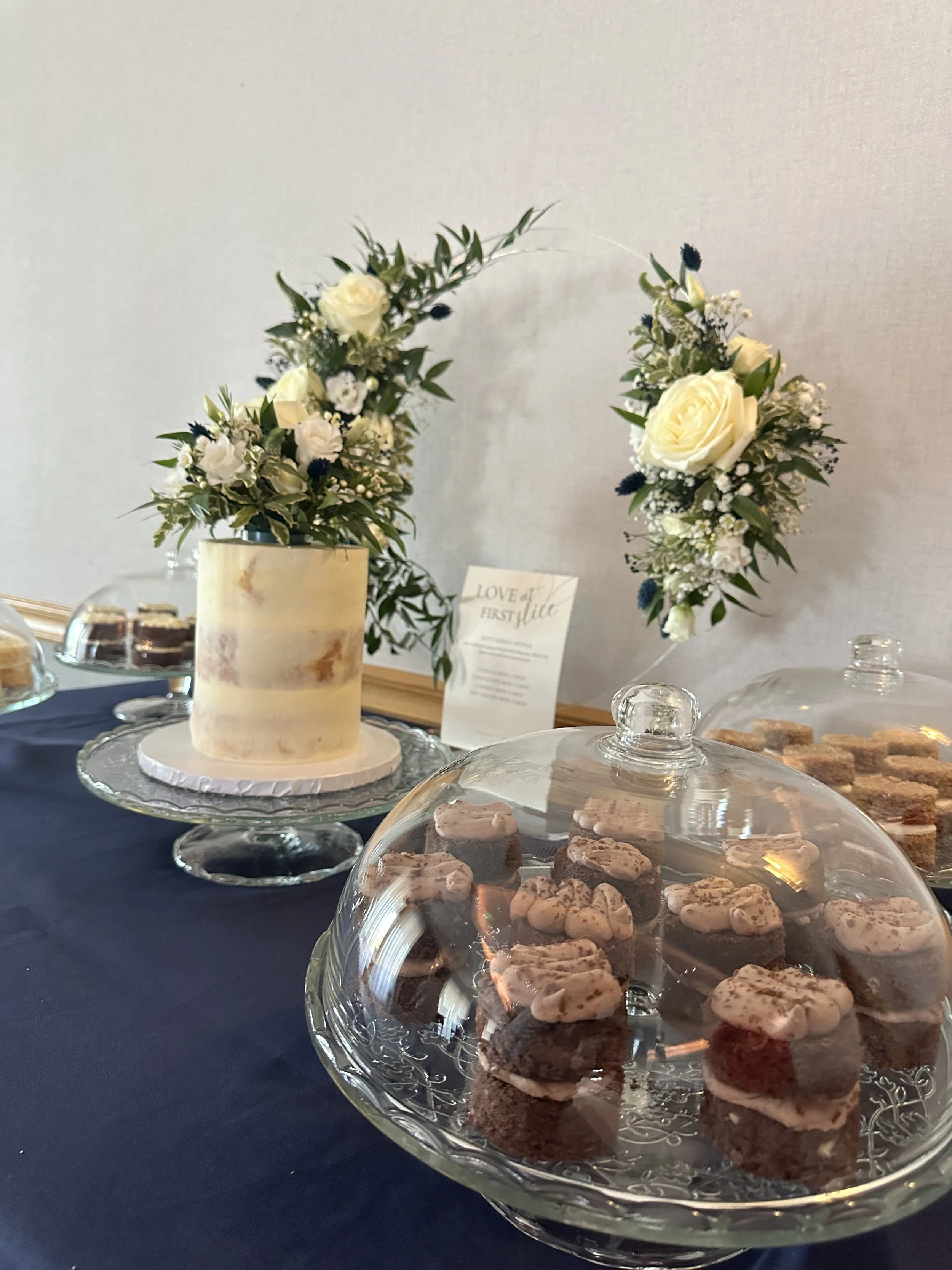 Rustic semi naked wedding cake with fresh flowers in Knutsford wedding venue