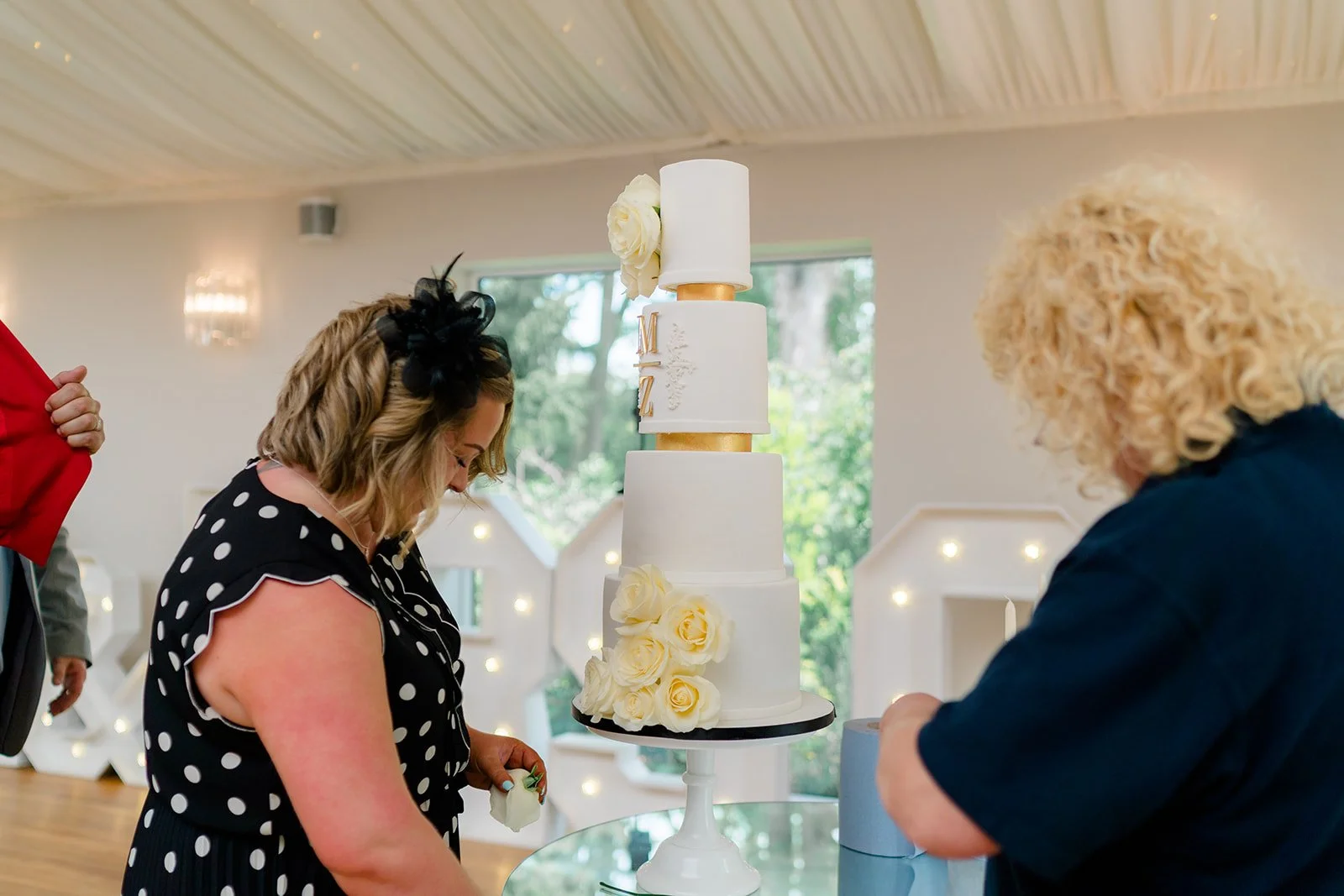 Setting up Molly and Zach's four-tier wedding cake in the marquee at Wrenbury Hall