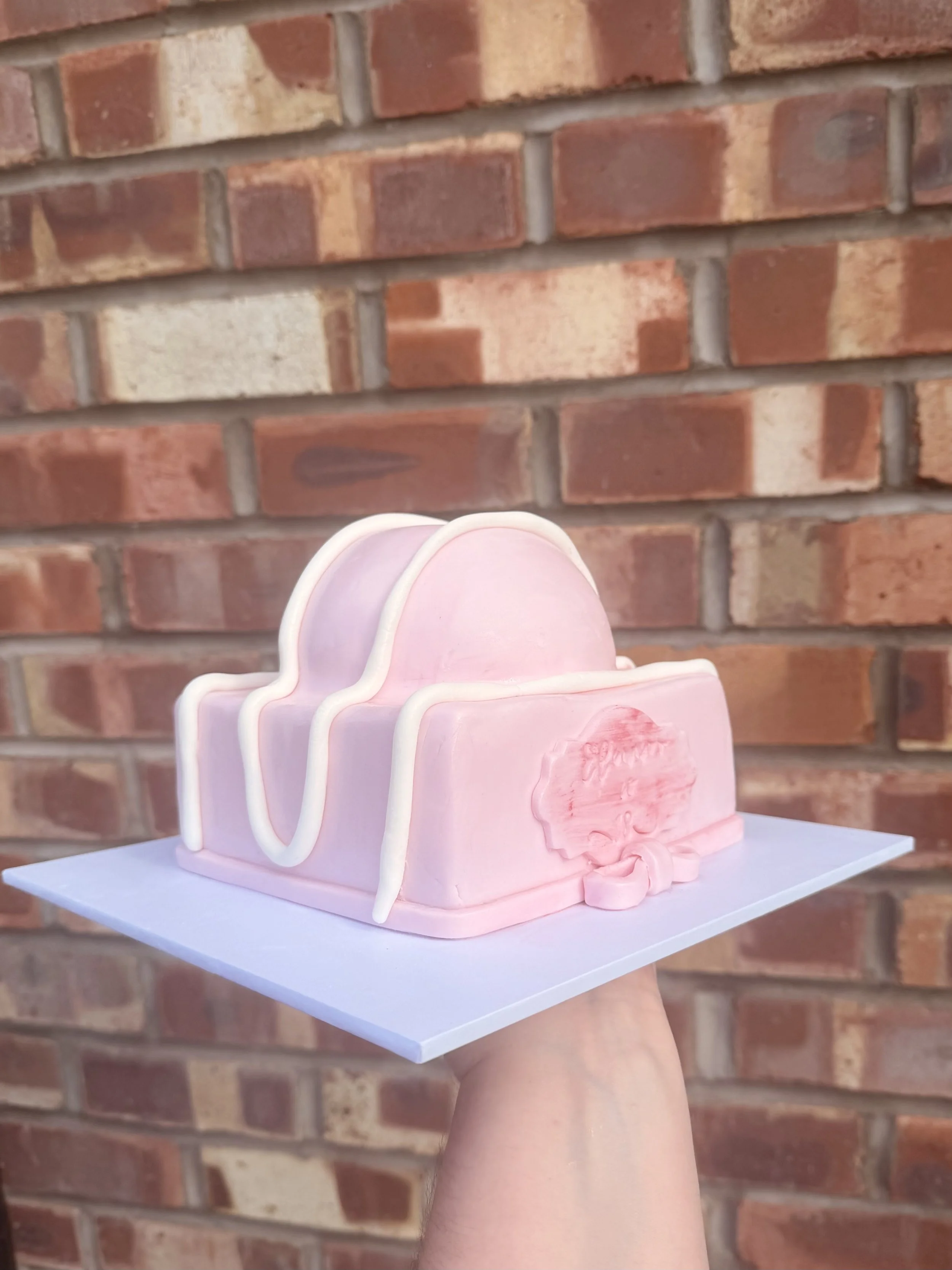 Pink celebration cake designed in the style of a traditional fondant fancy